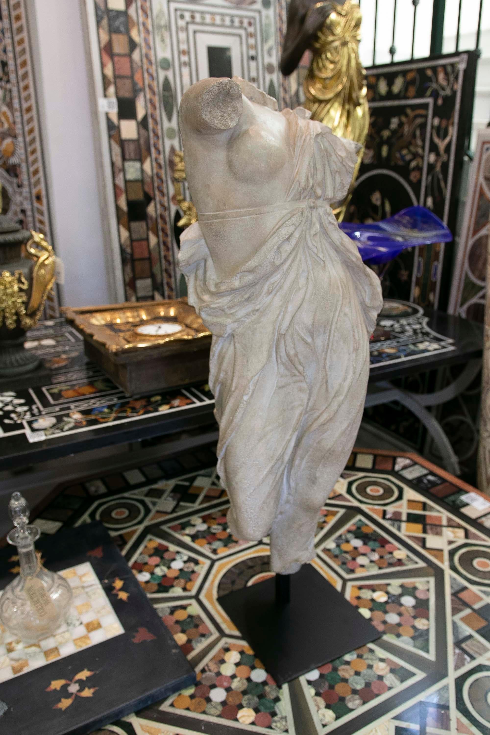 Classical Roman female dancing torso sculpture in resin imitating marble on an iron pedestal. Top quality antique imitation of the erosion and passing of time.
