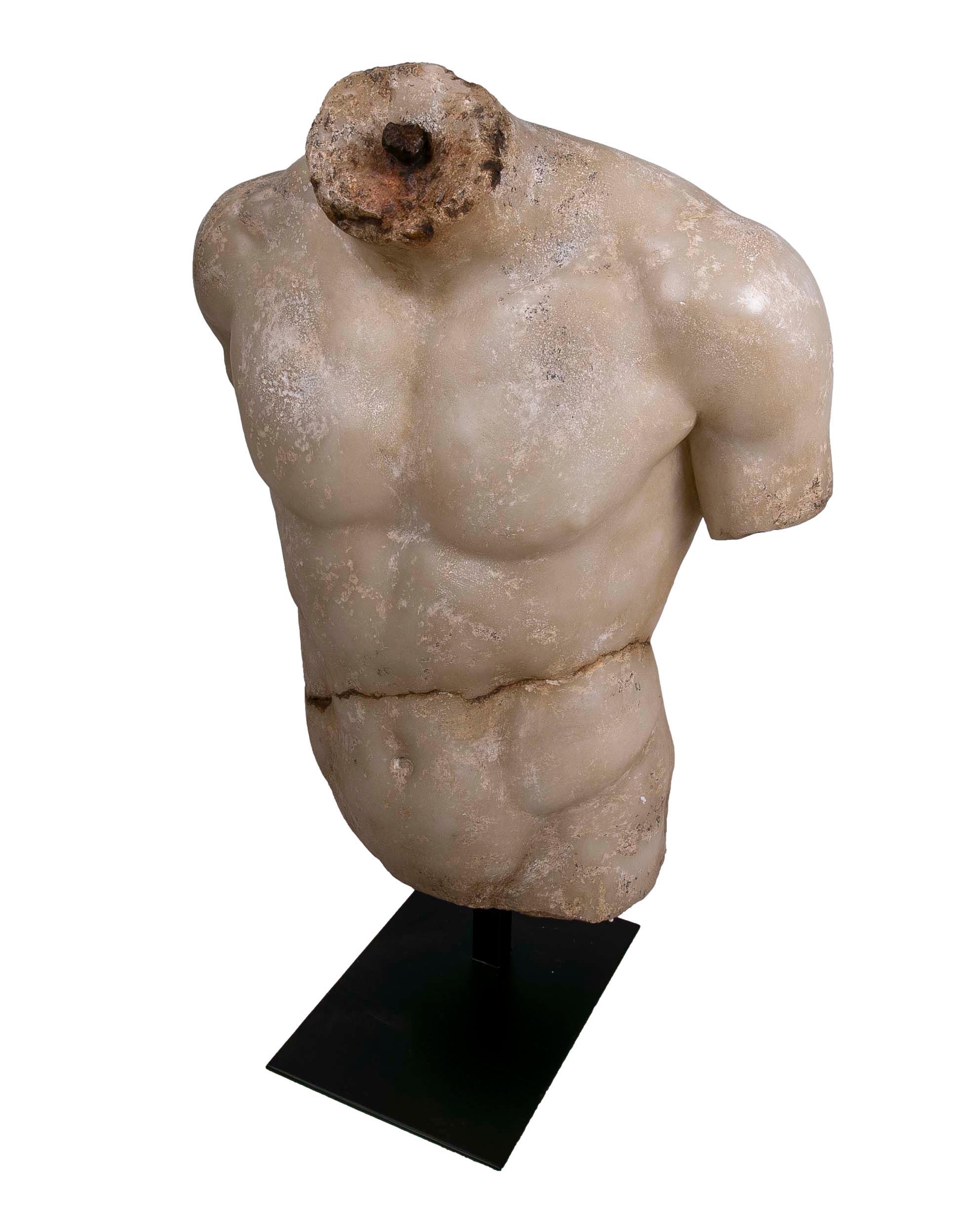 Classical Roman torso in resin imitating marble on iron pedestal.