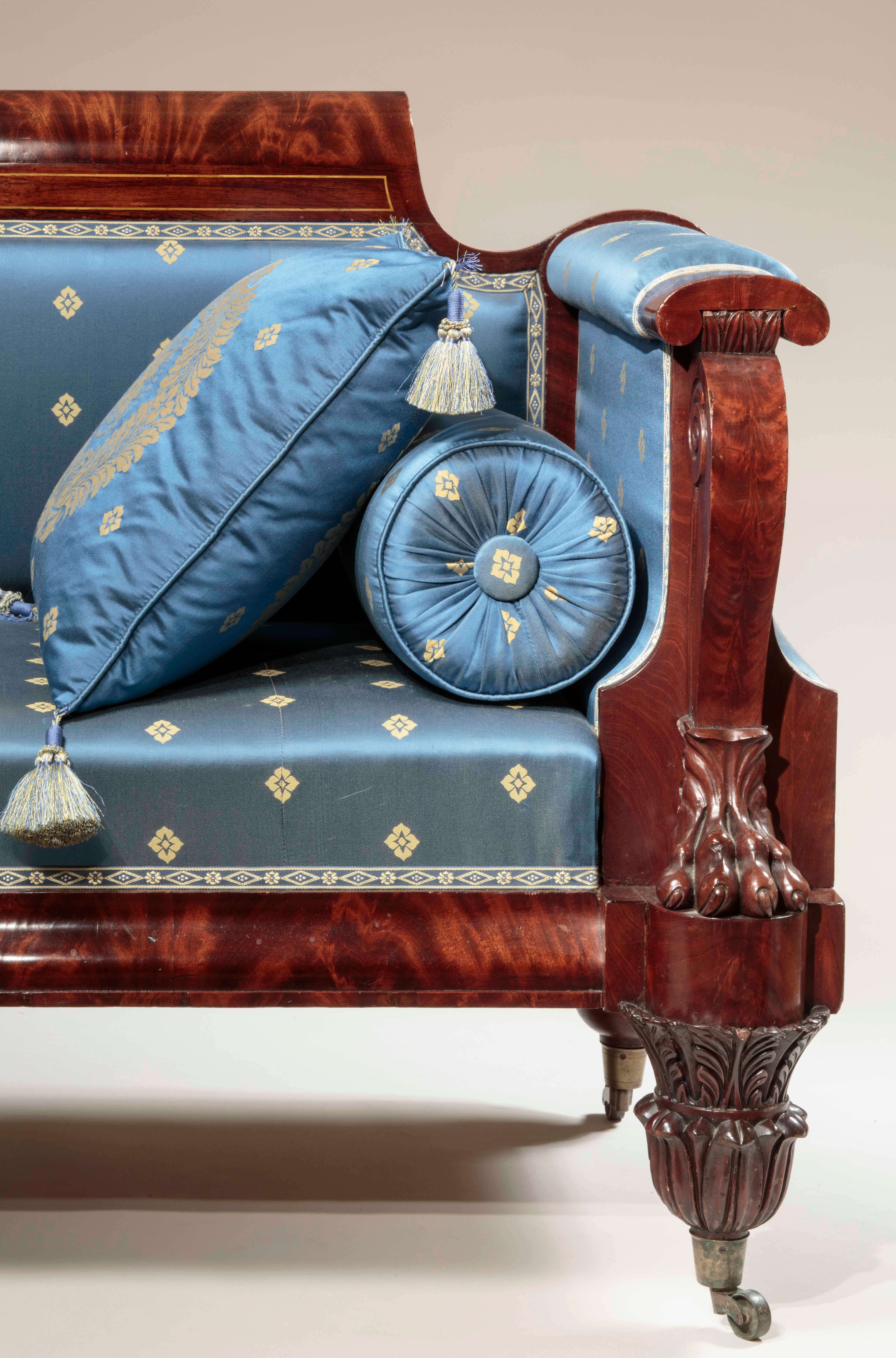 Attributed to Anthony G. Quervelle (1789-1856)
Philadelphia, circa 1830.

The scrolled crest with gilt stringing and inlaid rosewood above an upholstered back, and seat flanked by Ionic-shaped arms terminating in an Ionic capital with Lotus