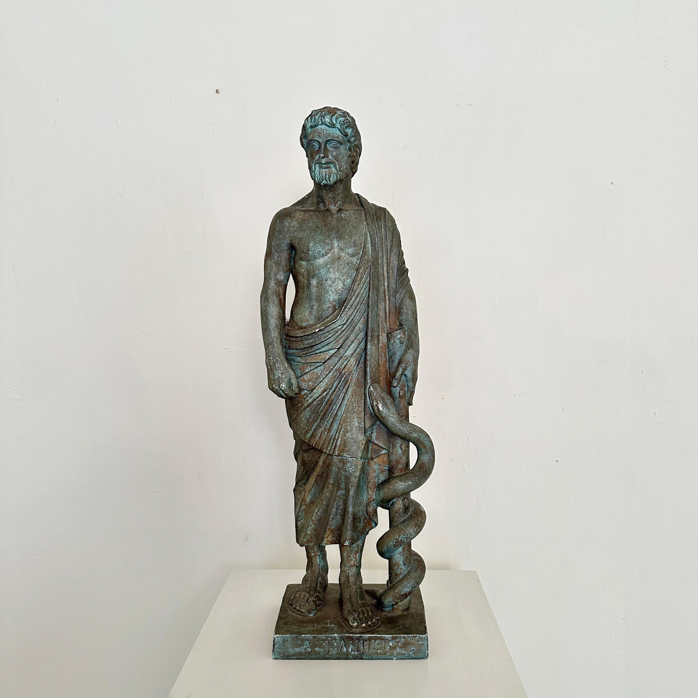 Crafted around 1960, the Classical Statue of Asklepios emerges as a timeless embodiment of healing and wisdom. Fashioned from patinated plaster, it exudes an aura of ancient reverence, capturing the essence of the revered Greek god of medicine.