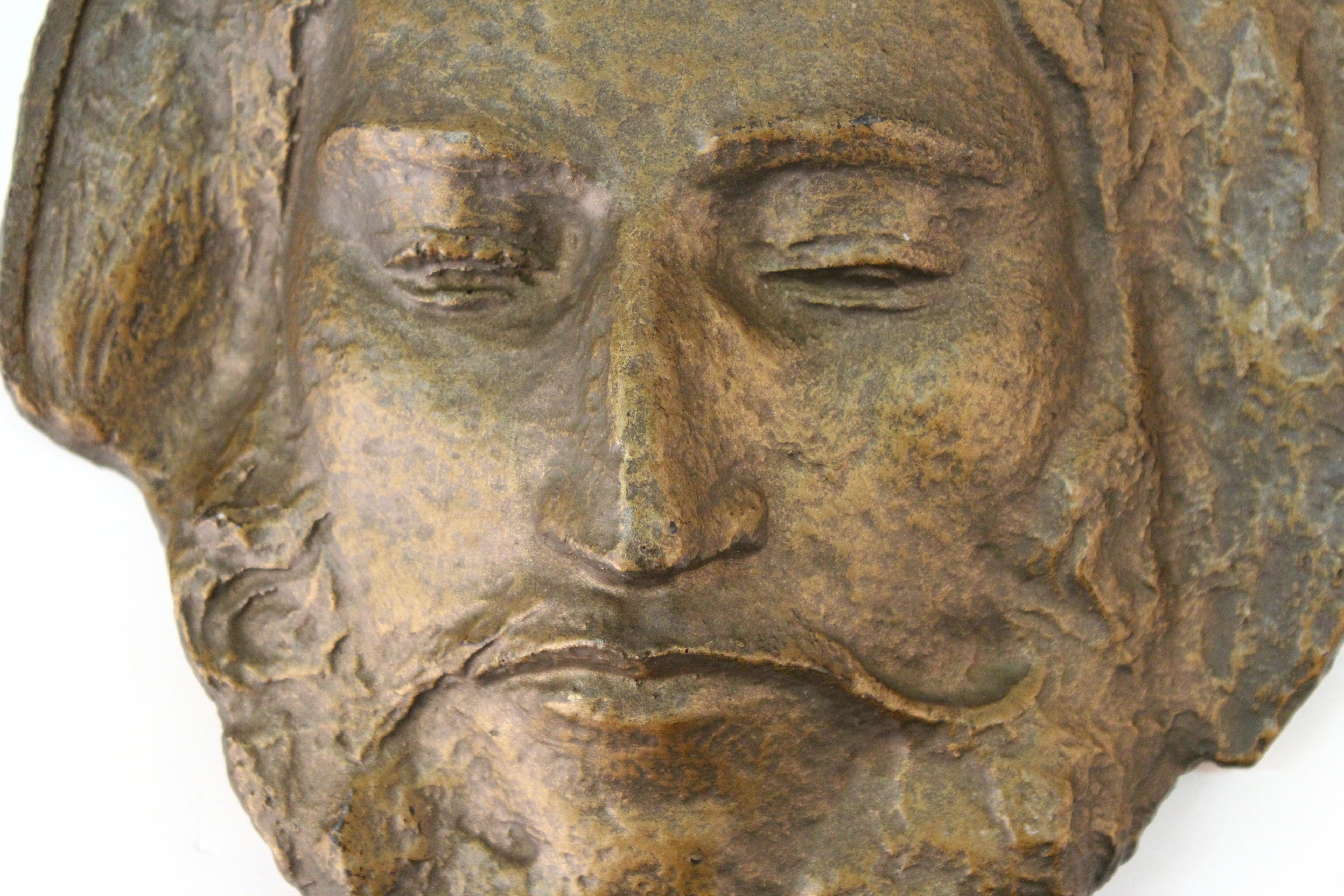 Classical style sculpted face of Paul Gauguin, in bronzed plaster. The piece has a mount on the back to hang on a wall and has an artists mark on the bottom edge. In good vintage condition with age-appropriate patina.