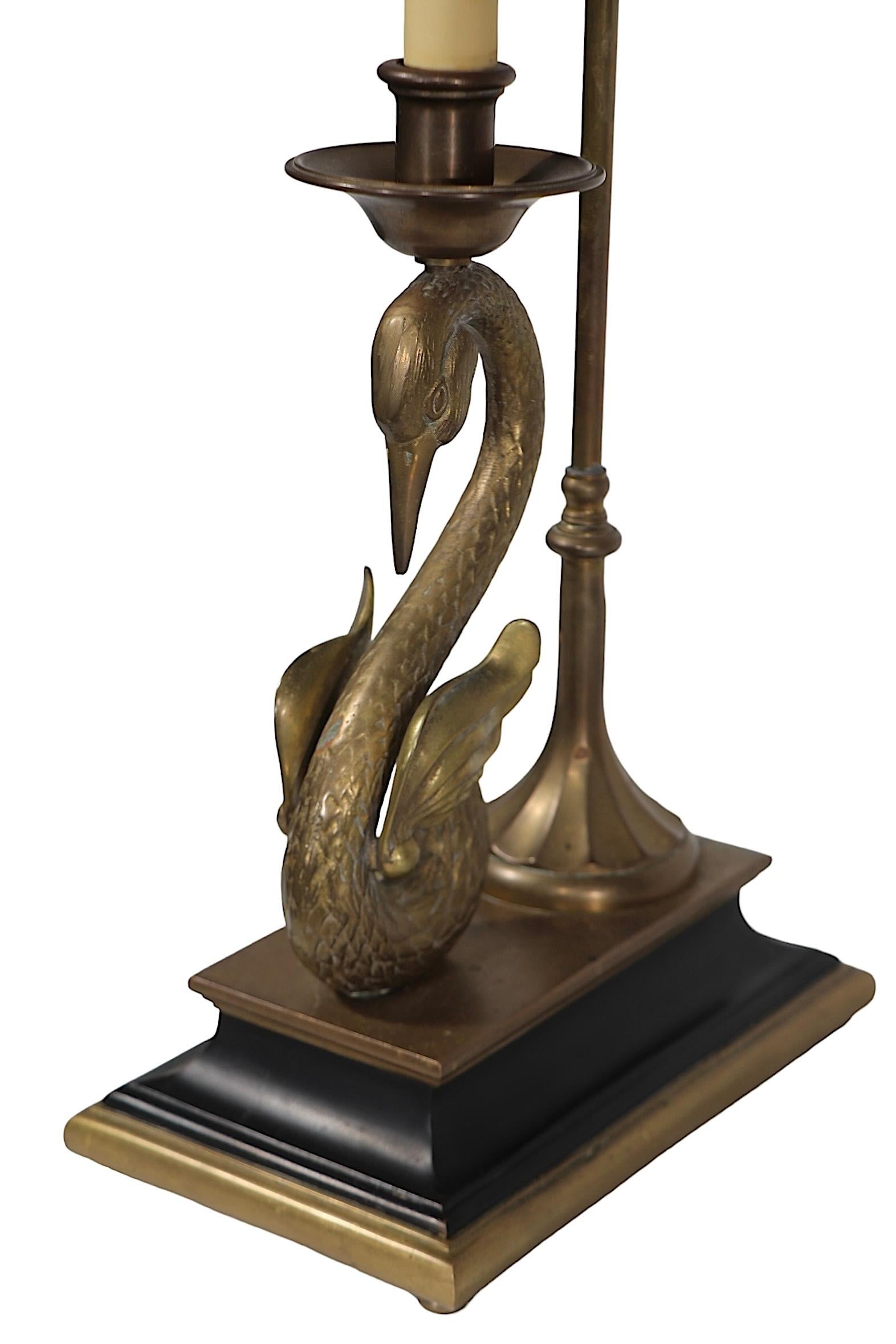 Exceptional classical  French style desk lamp by  the Chapman Manufacturing Company. This example features a finely cast brass swan, with adjustable bouillotte style shade in black paint finish.  Hood shade is adjustable in height and pivots on the