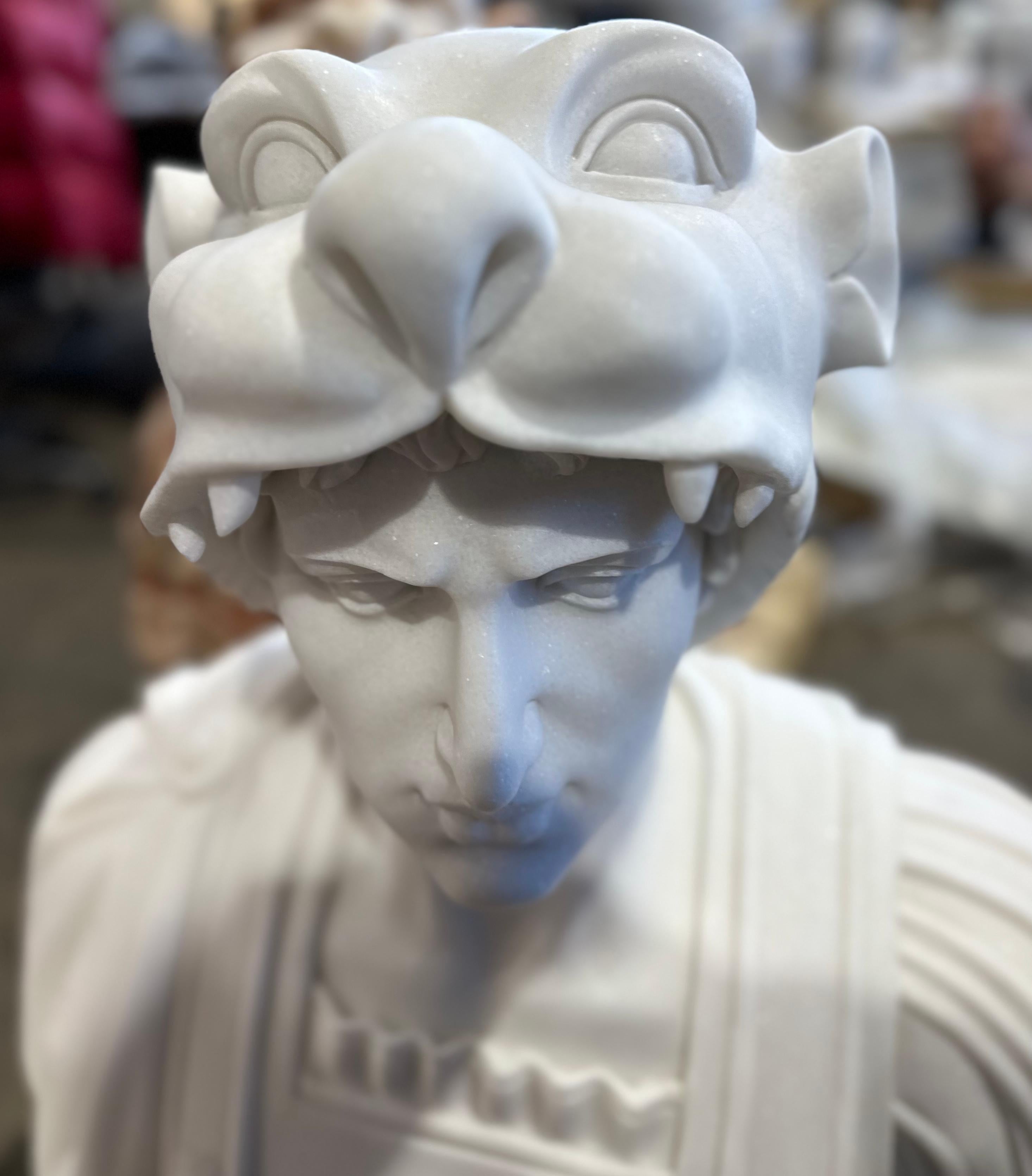A handsome Classical style bust in white marble. Skilfully carved with clear features and a unusually decorative helmet depicting a wild cat suggestive of a puma. The teeth are beautifully carved with detailing to the cats face. There is also lovely