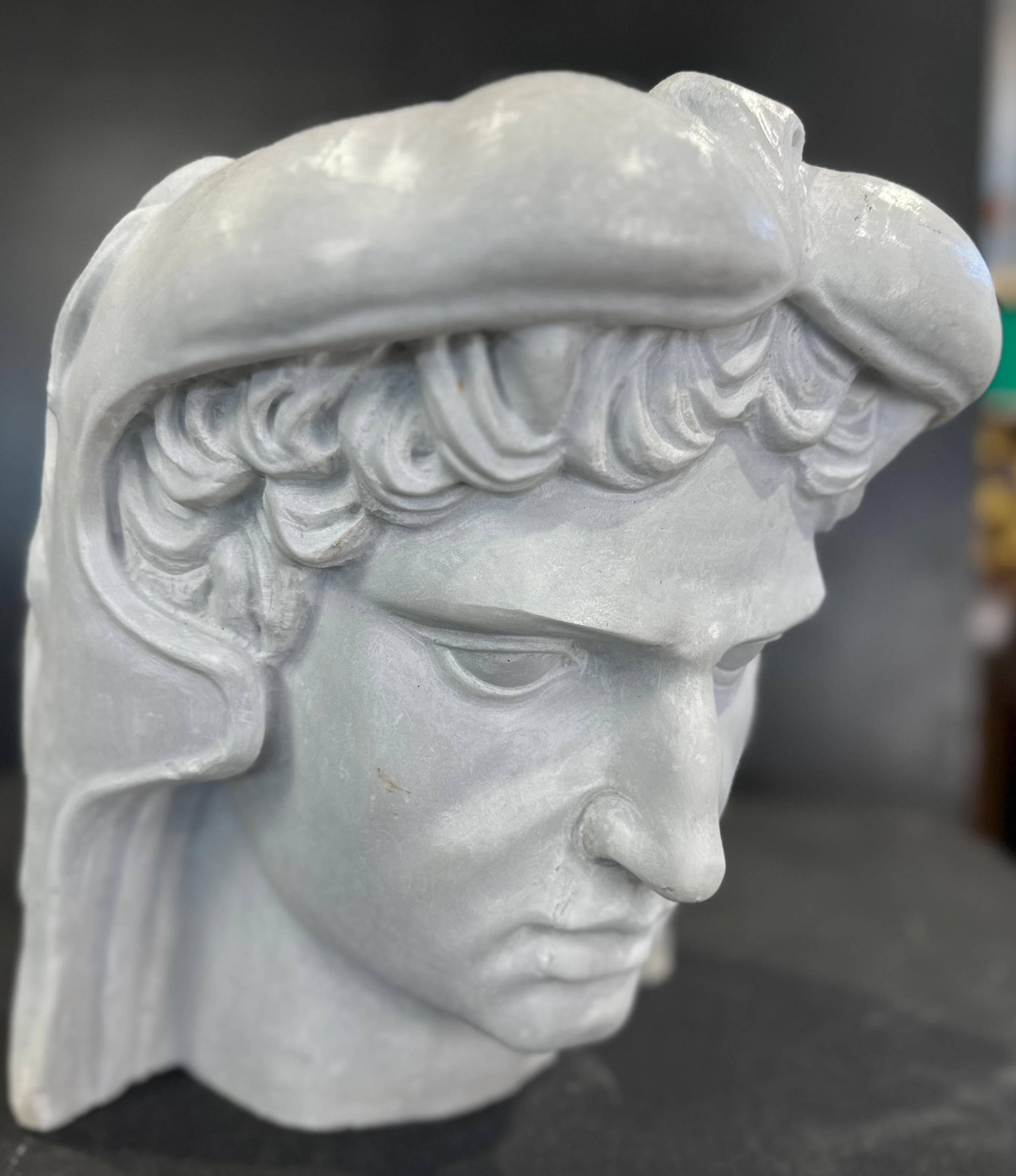 Beautifully hand carved marble head. The carving is well executed with clear features including curling hair and aquiline nose. Wearing a helmet carved as wildcat skin. 

This piece would look great as a table piece or as part of a collection.