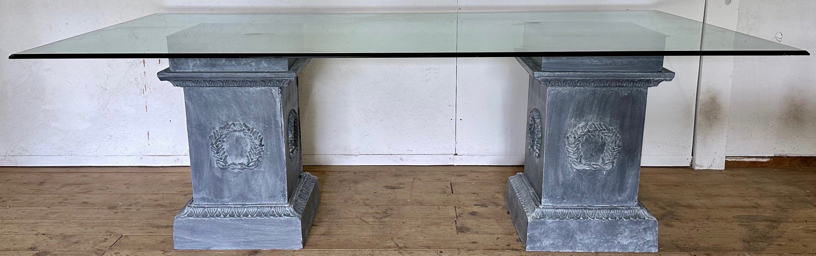 Pair of  Neoclassical Style cast iron square pedestal bases with wreath design on all sides can be used either indoor or outdoor for dining table base, conference table or use as pedestals for sculptures, plants or flower arrangements.
Listing is