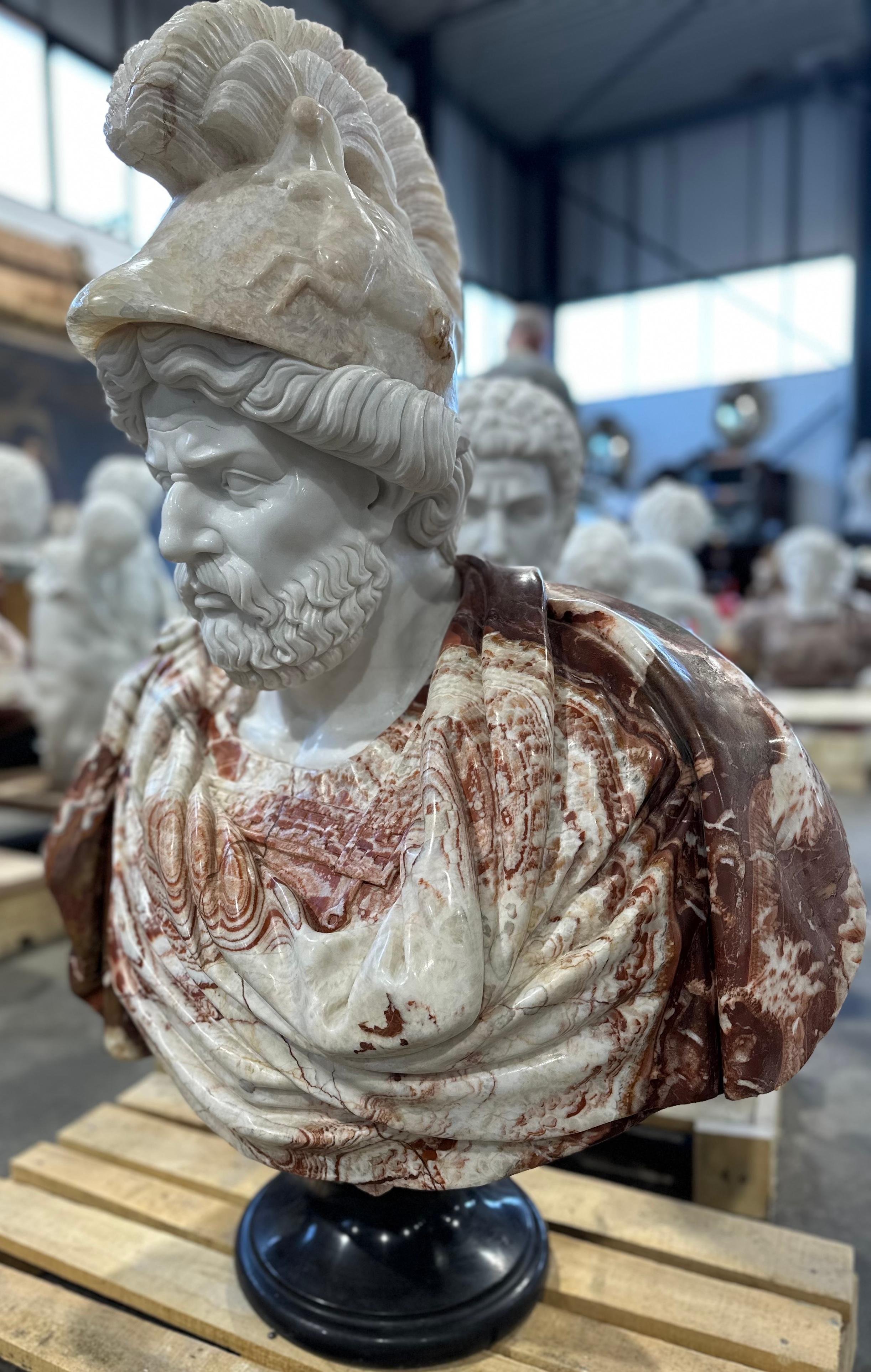 Handsomely and skilfully carved, two coloured marble male bust on black marble stand, in the classical style.
The features are clear, with detailing showing the curled hair and beard. The clothing is carved in smooth folds showing the beauty and