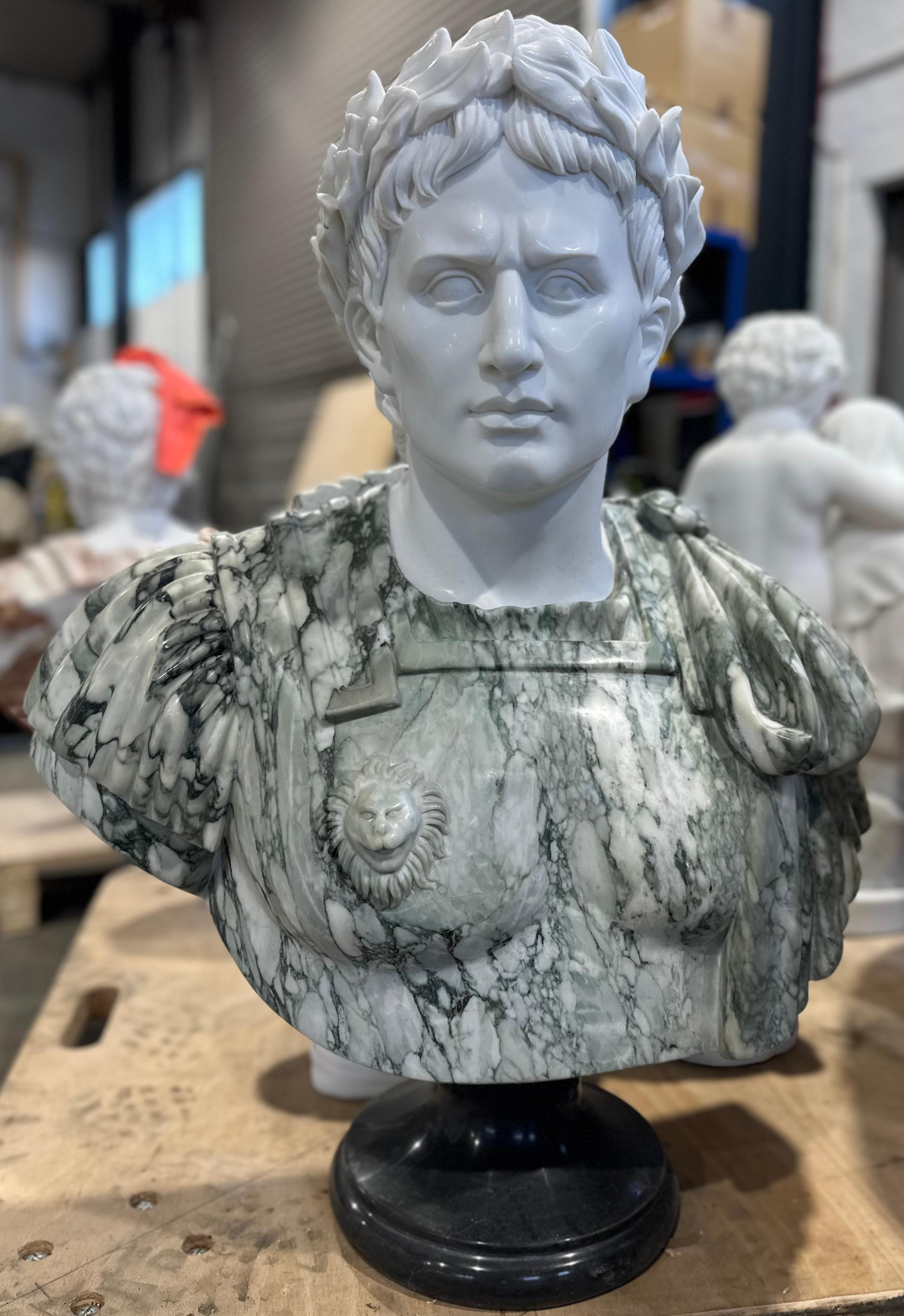 A striking green and white marble male bust. Detailed and skilfully carved with additional decoration on the breastplate showing a lions head. The males profile is presented with ruffled hair, clear features and wearing a intricate laurel wreath.