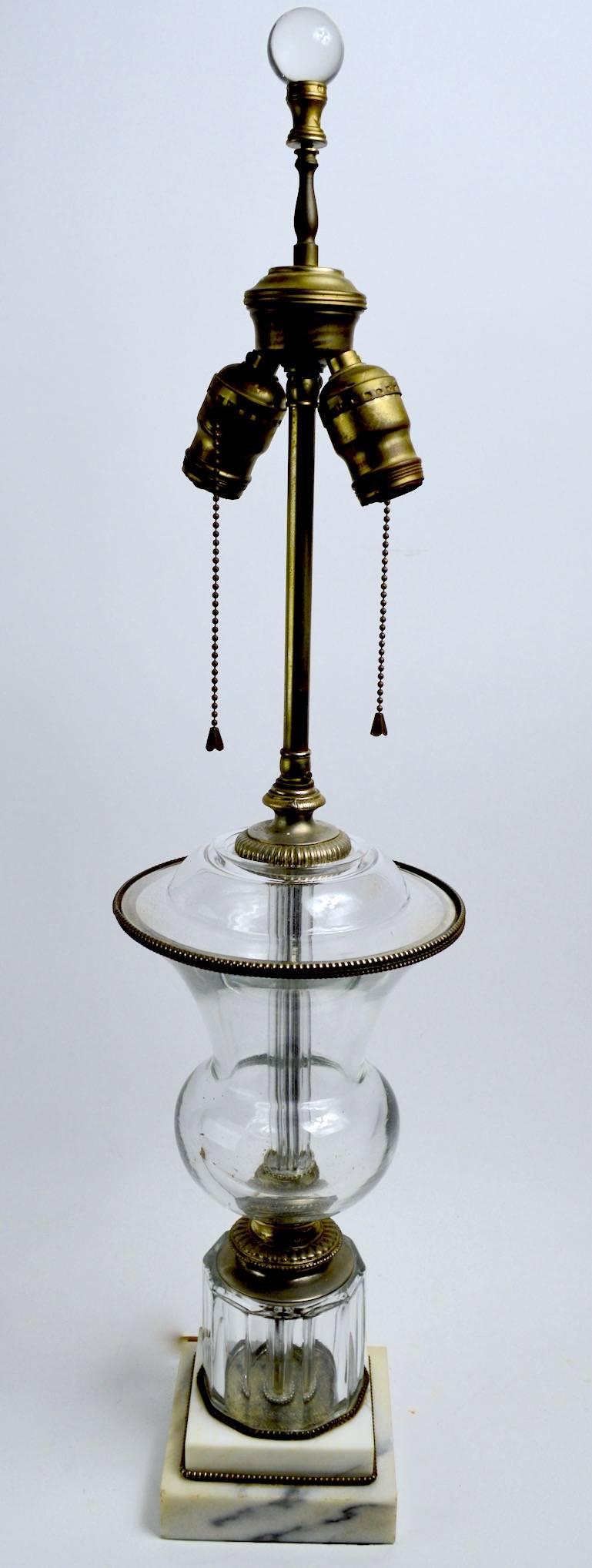 Classical form glass lamp with cast metal trim, on stepped marble base. Unknown maker, in the style of Baccarat. Height tom top of lamp body 15 inch x 7 inch diameter. Clean working condition, minor dust inside lamp body, shade not included.