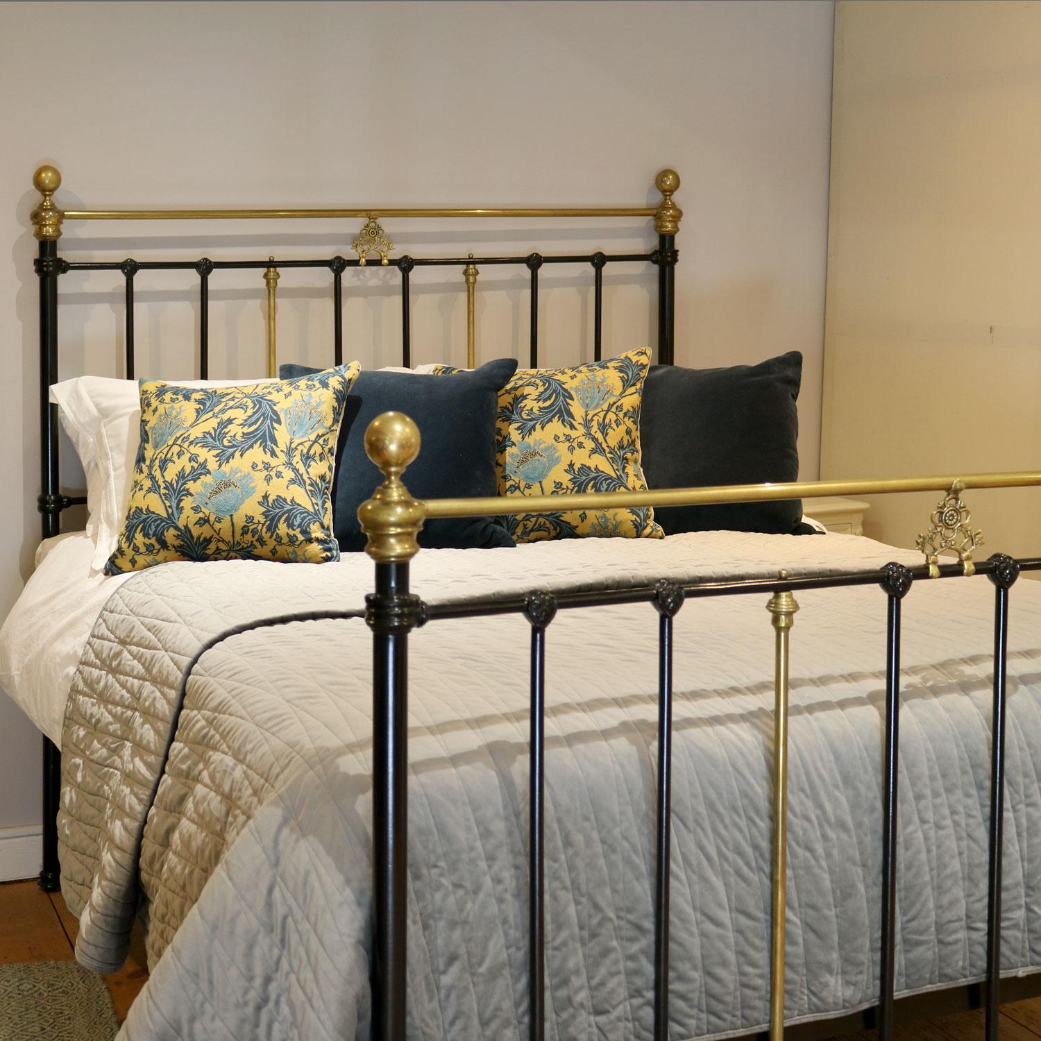 Classical Victorian cast iron and brass bedstead, with elegant cast brass plaque in the centre of the head and foot panels under the straight brass top rails. 

This bed accepts a UK King size or US Queen size (5ft, 60in or 150cm wide) base and