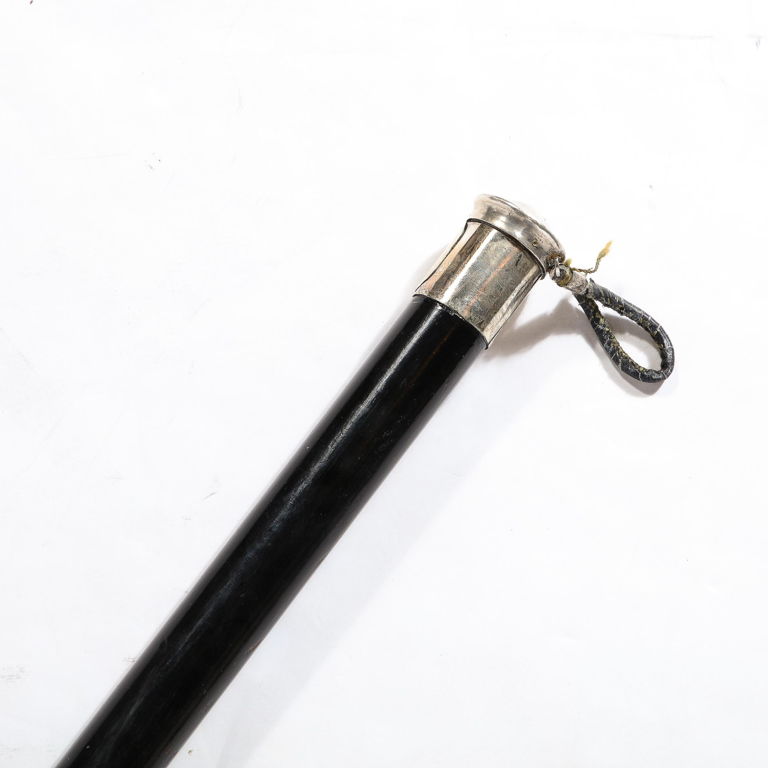 This Classical Walking Stick in Ebonized Walnut & Sterling Pommel W/ Heraldic Crest originates from France during the Late 19th Century. Features a elegant and timeless profile with a lovely pommel in sterling silver. The pommel is formed by a