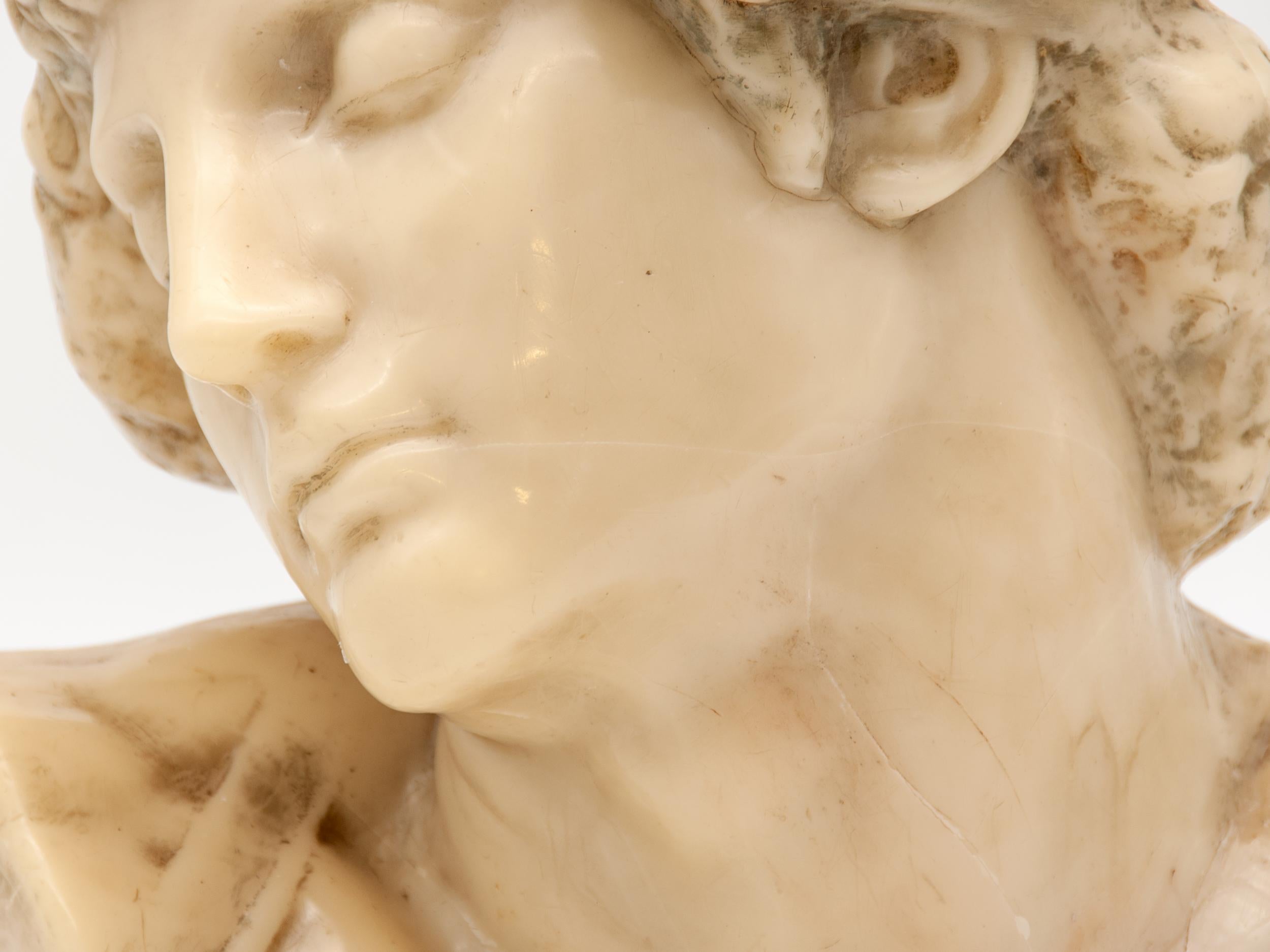 An early 20th century fine wax bust in a classical Roman style. This classical sculpture wax bust features a beautiful statuesque face with fine detail around the hair and ear. Wax busts are increasingly rare, particularly in this style and