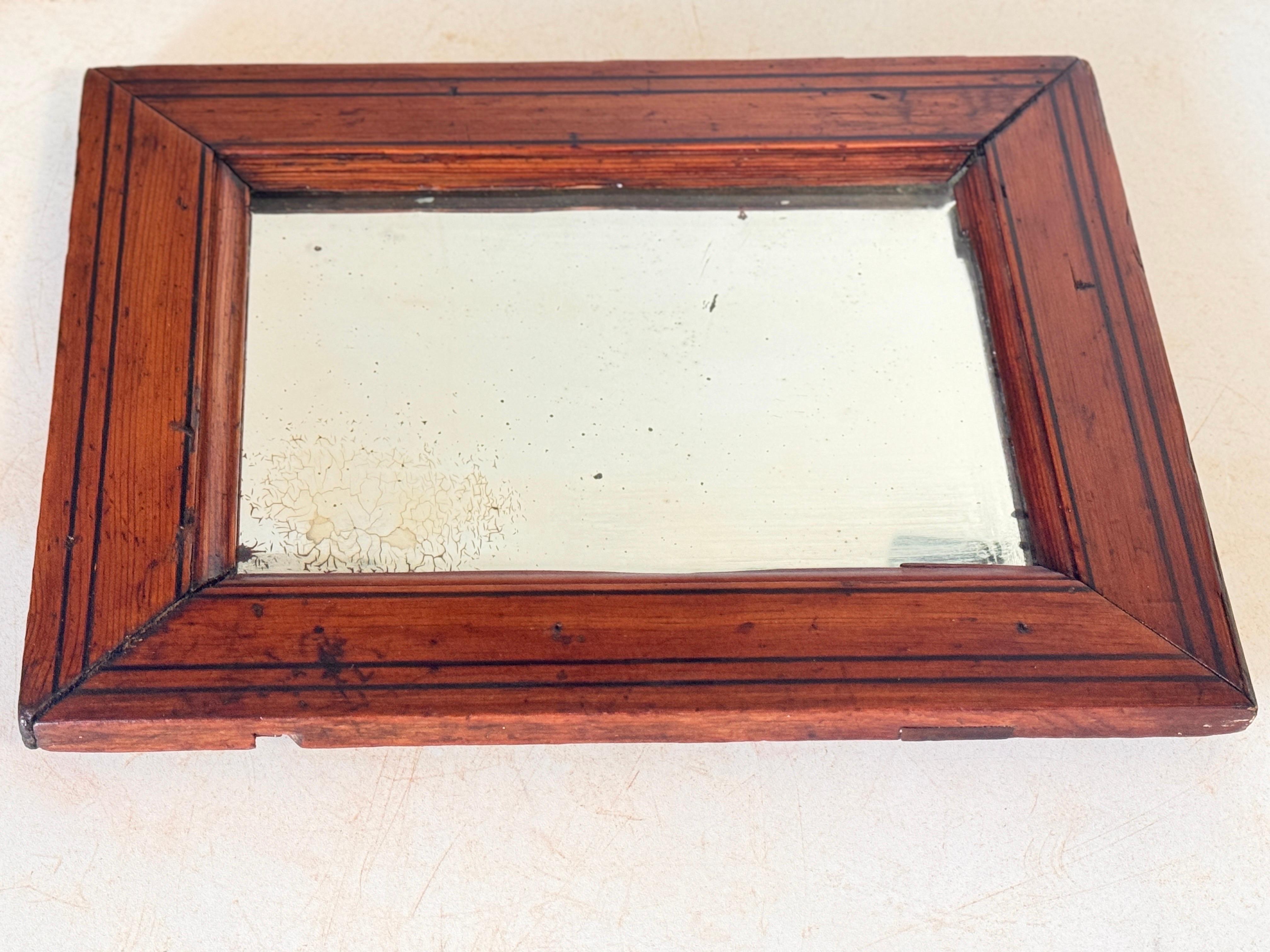 Mirror in wood, in a brown color, old glass mirror, circa 1940.