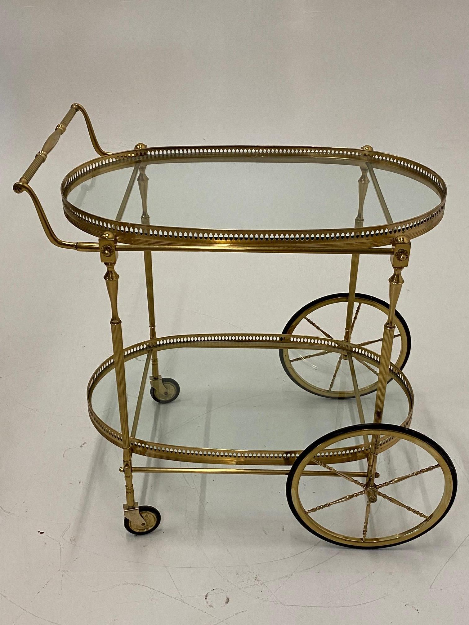 LaBarge elegant solid brass vintage bar cart having two oval glass tiers with gallery surrounds. 
Measures: 30 H to handle
28 H to top tier gallery
9.5 H to bottom tier gallery.
 