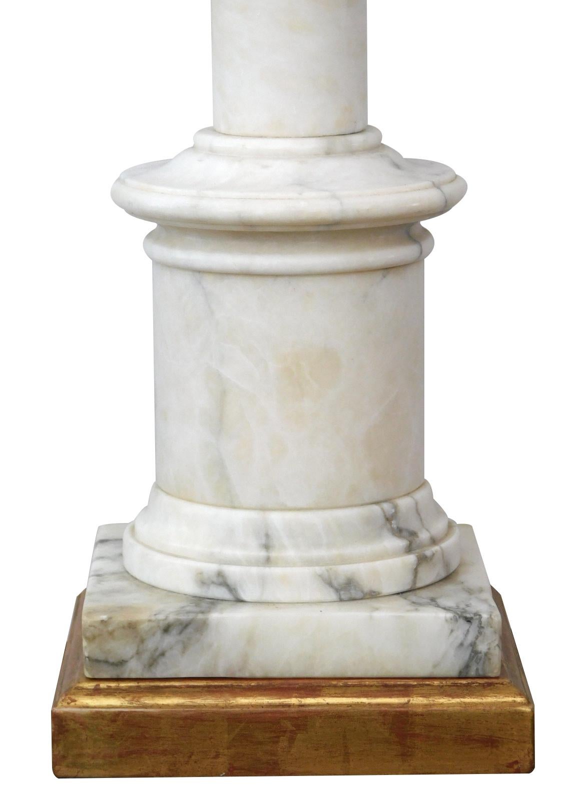 with giltwood neck above a turned columnar body of nicely figured Carrara marble all over a giltwood base; height: 15.25