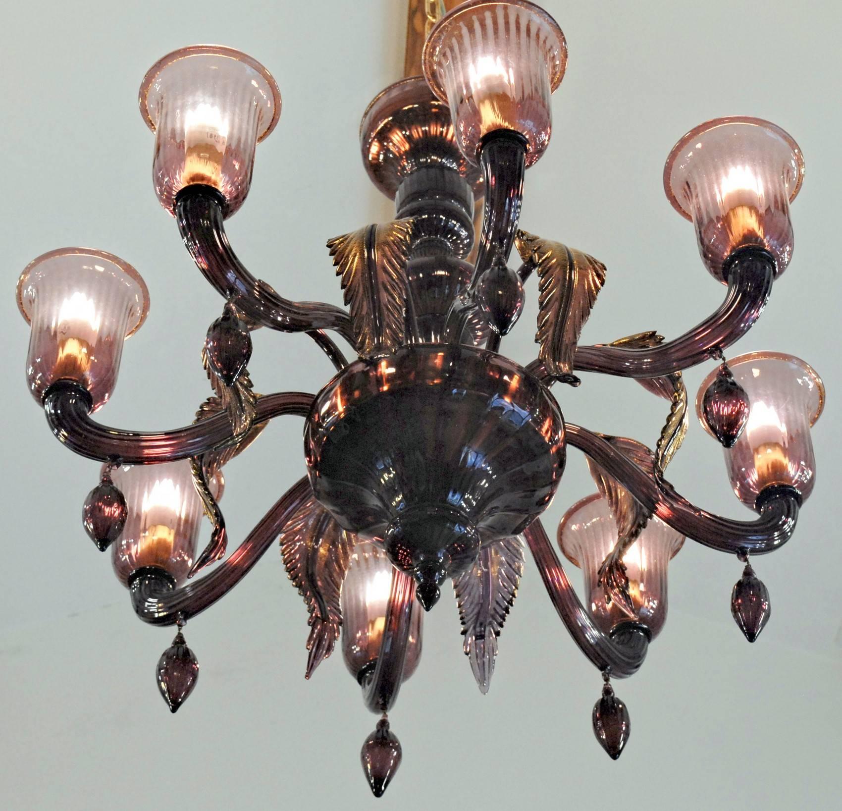 Exquisite Amethyst chandelier. Classic design with a warm version of Amethyst, perhaps coated (mezza tinta) with amber. Eight arms with pendant and rigadin pattern (ribbed). Each arm is spaced by hand made leaf with gold leaf application that gets