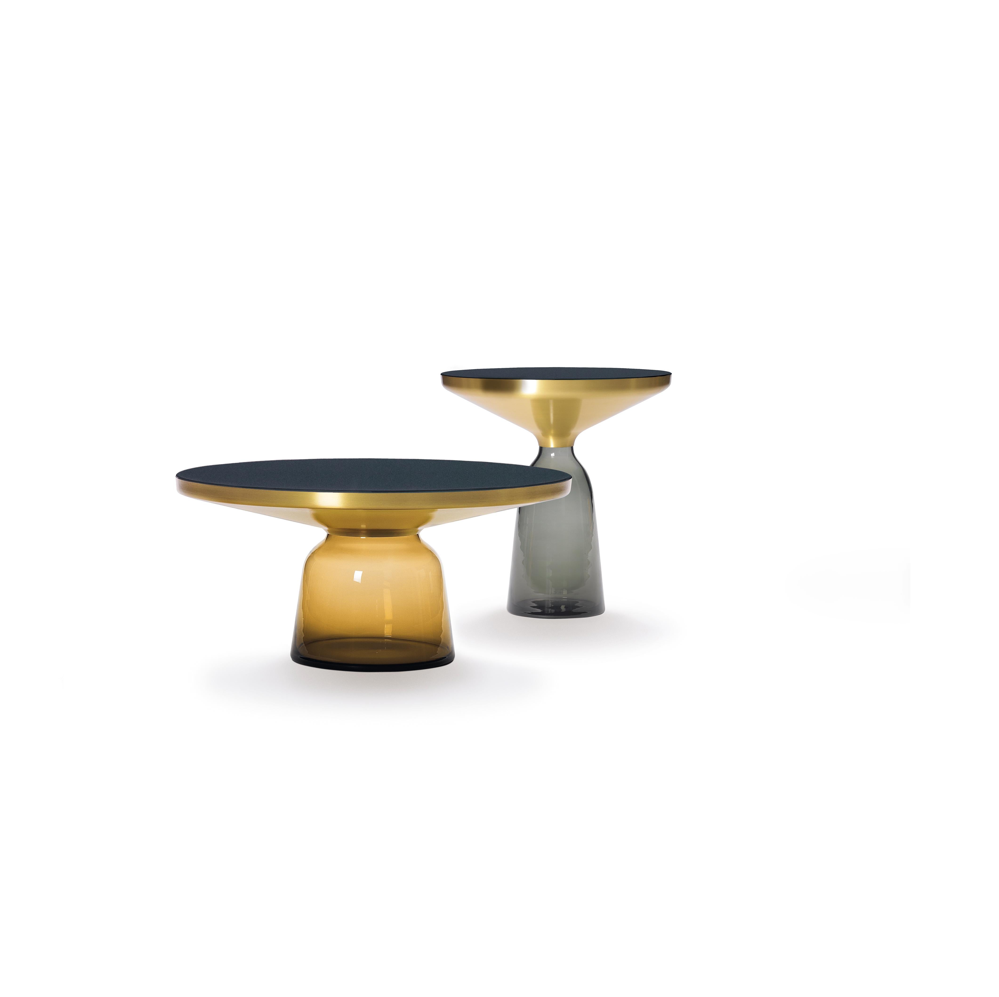 The bell table by Sebastian Herkner turns our perceptual habits on their head, using the lightweight, fragile material of glass as base for a metal top that seems to float above it. Hand blown in the traditional manner using a wooden mold, the