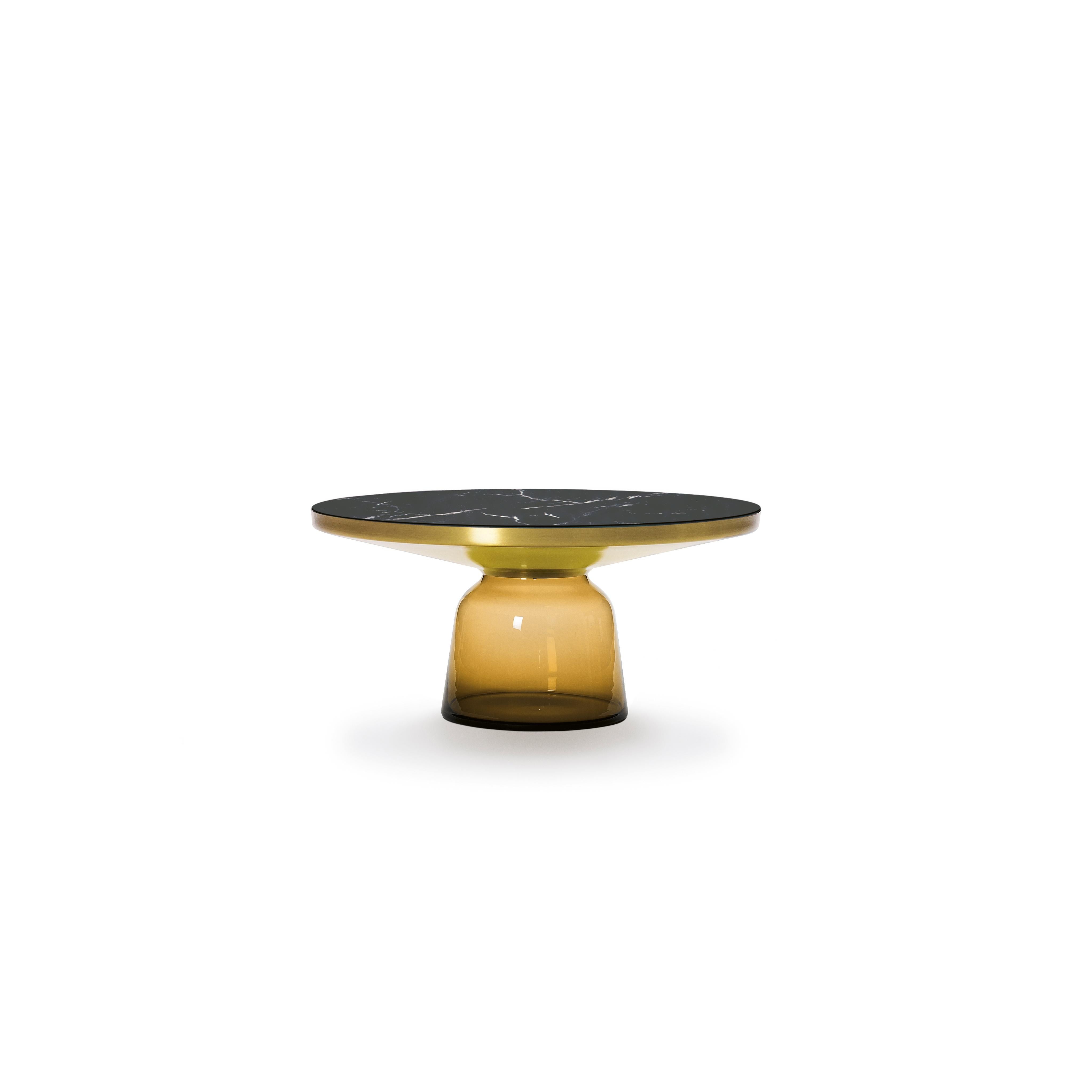 The bell table by Sebastian Herkner turns our perceptual habits on their head, using the lightweight, fragile material of glass as base for a metal top that seems to float above it. Hand blown in the traditional manner using a wooden mold, the