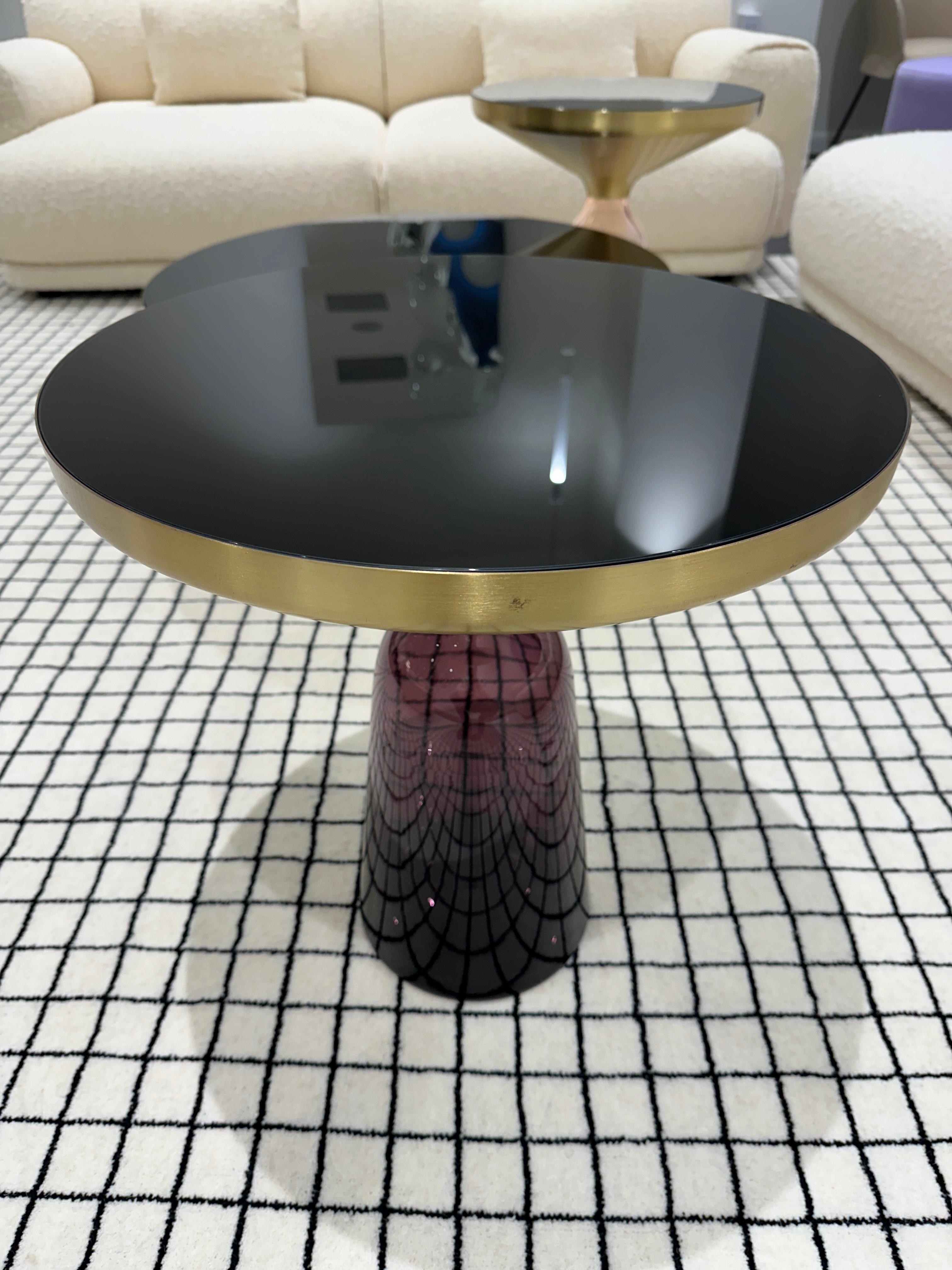 The bell table by Sebastian Herkner turns our perceptual habits on their head, using the lightweight, fragile material of glass as base for a metal top that seems to float above it. Hand blown in the traditional manner using a wooden mold, the
