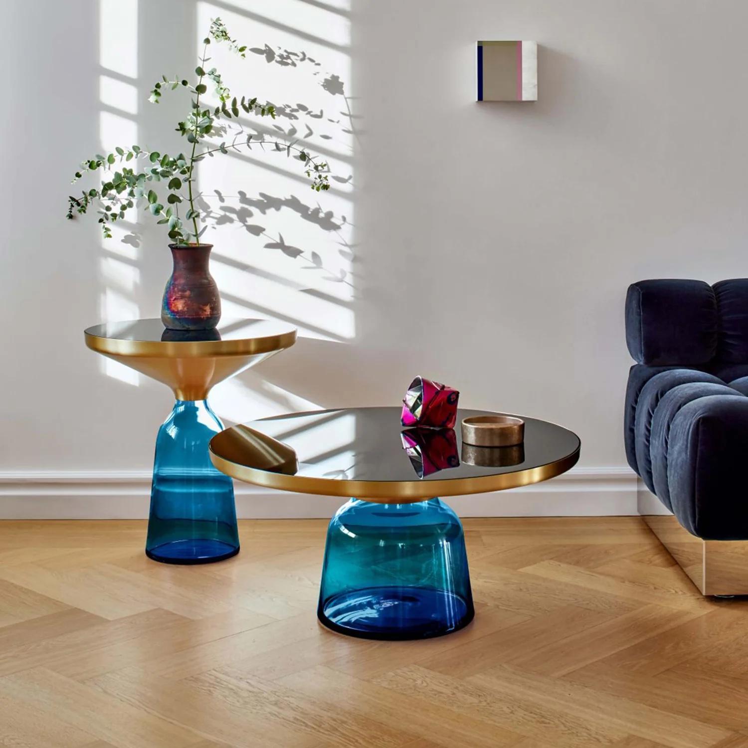 **Showroom Sample**
The bell table by Sebastian Herkner turns our perceptual habits on their head, using the lightweight, fragile material of glass as base for a metal top that seems to float above it. Hand blown in the traditional manner using a
