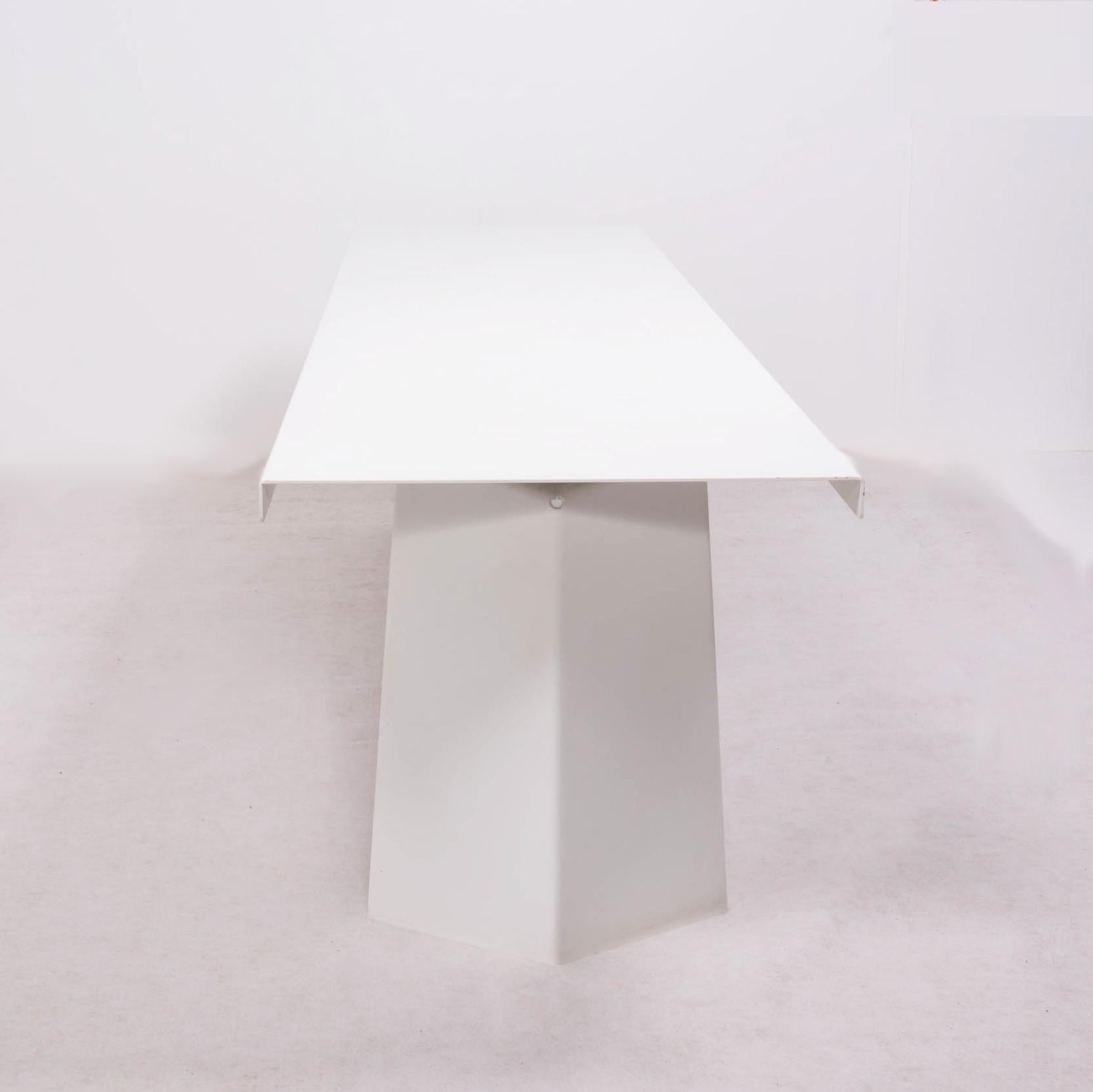 A Konstantin Grcic for ClassiCon design Classic.
 Finished in sheet steel with a fine-texture white powder coating, the modern Industrial Pallas dining table sits atop two wide angled legs, creating a bold silhouette. 
The bright, modern aesthetic
