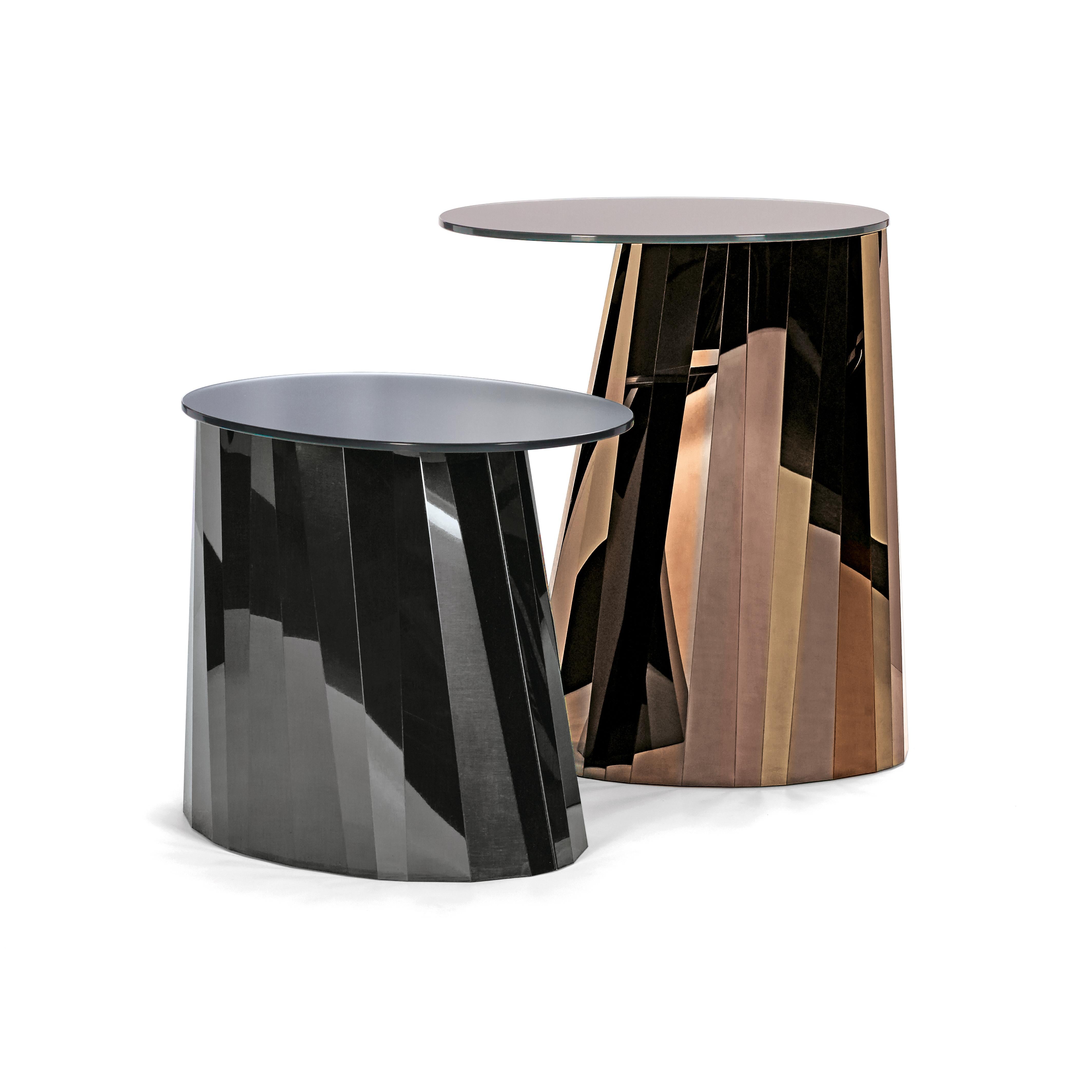 With the Pli side table series French designer Victoria Wilmotte brings objects of unusual crystalline elegance and astonishing geometry to living environments. The bends and folds that gave Pli its name almost make the stainless steel base look