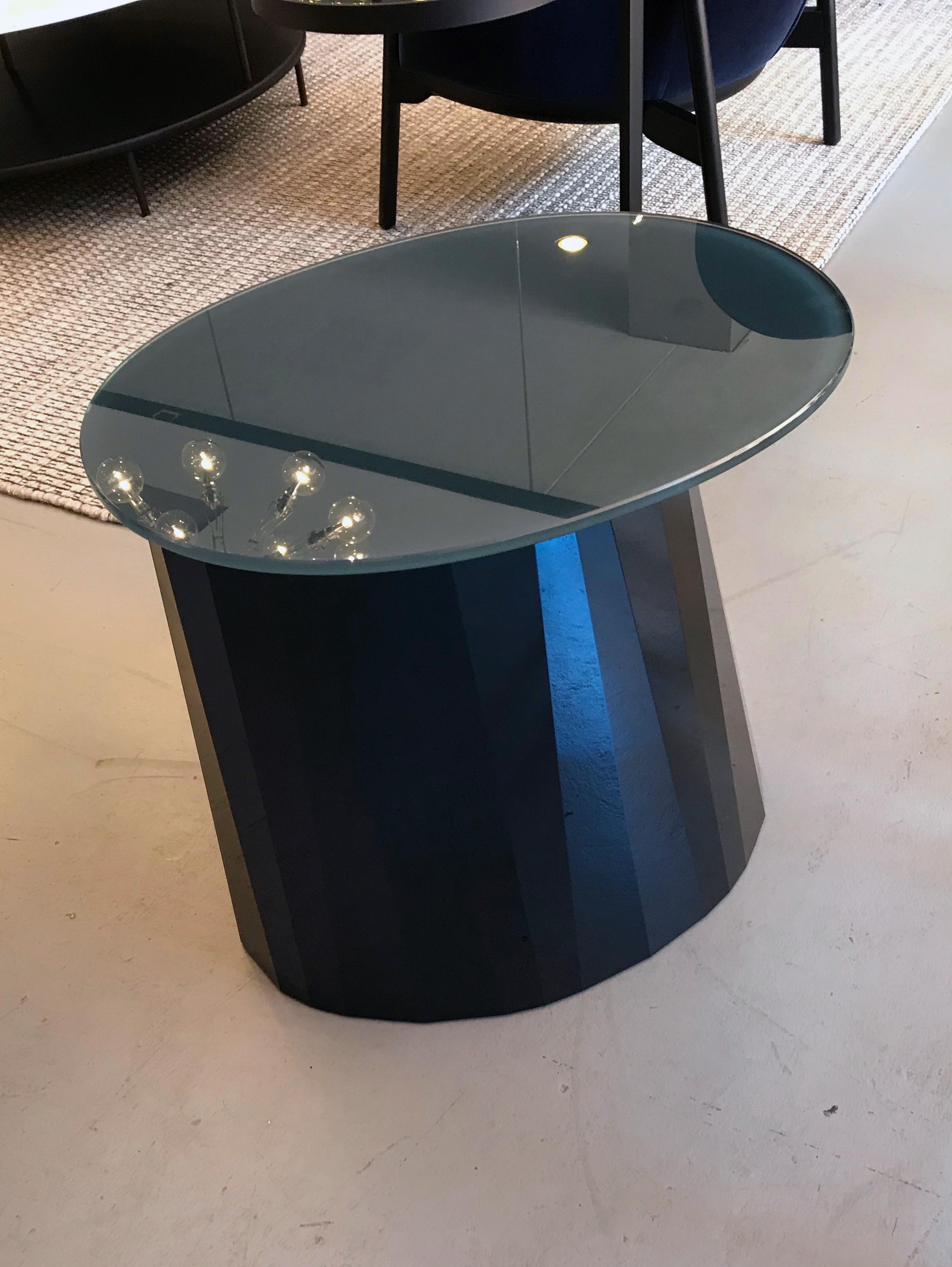 With the Pli side table French designer Victoria Wilmotte brings objects of unusual crystalline elegance and astonishing geometry to living environments. The bends and folds that gave Pli its name almost make the stainless steel base look like an
