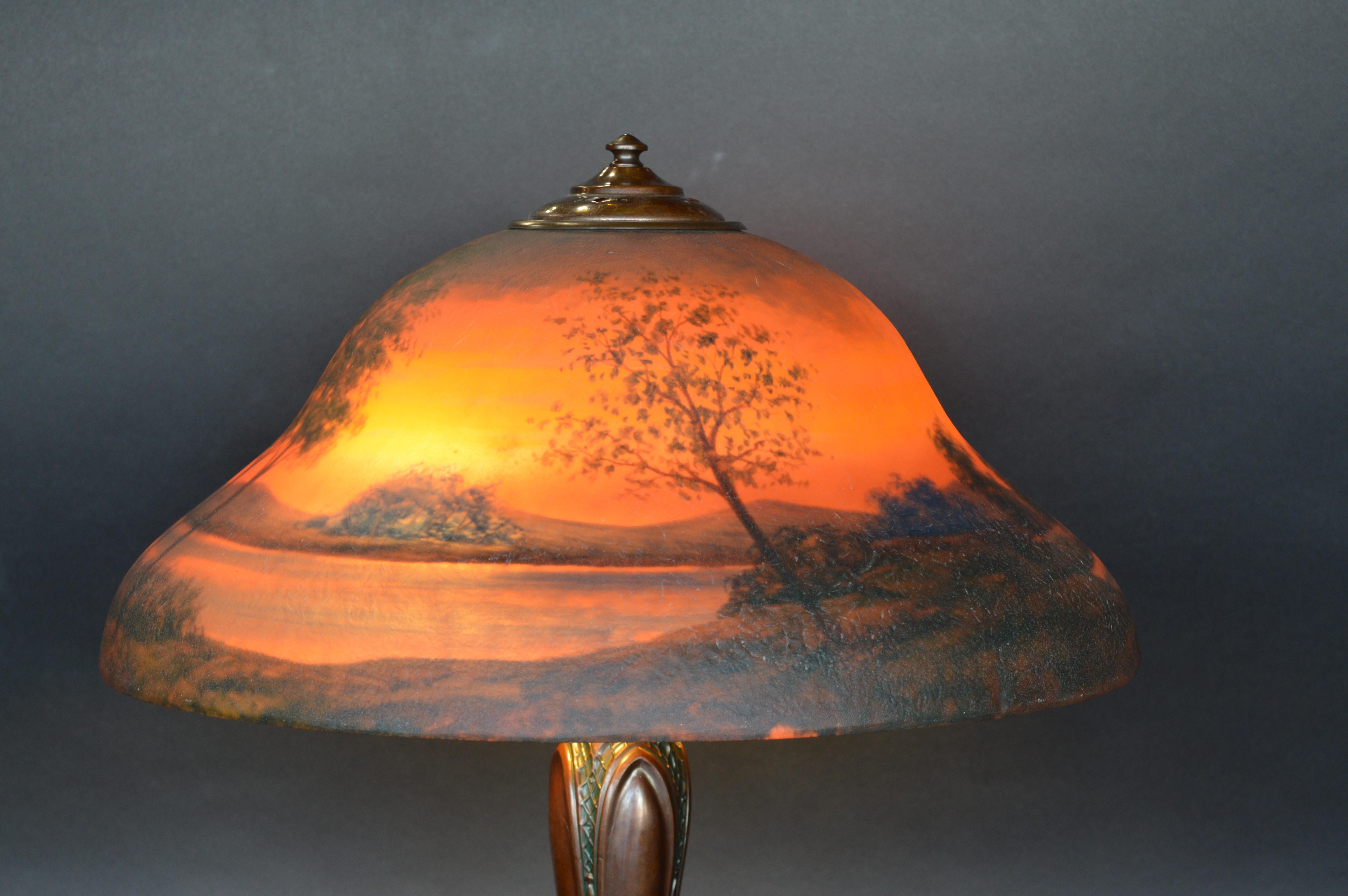 Classique sunset landscape table lamp, circa 1920. Reverse painted. Patinated metal base.