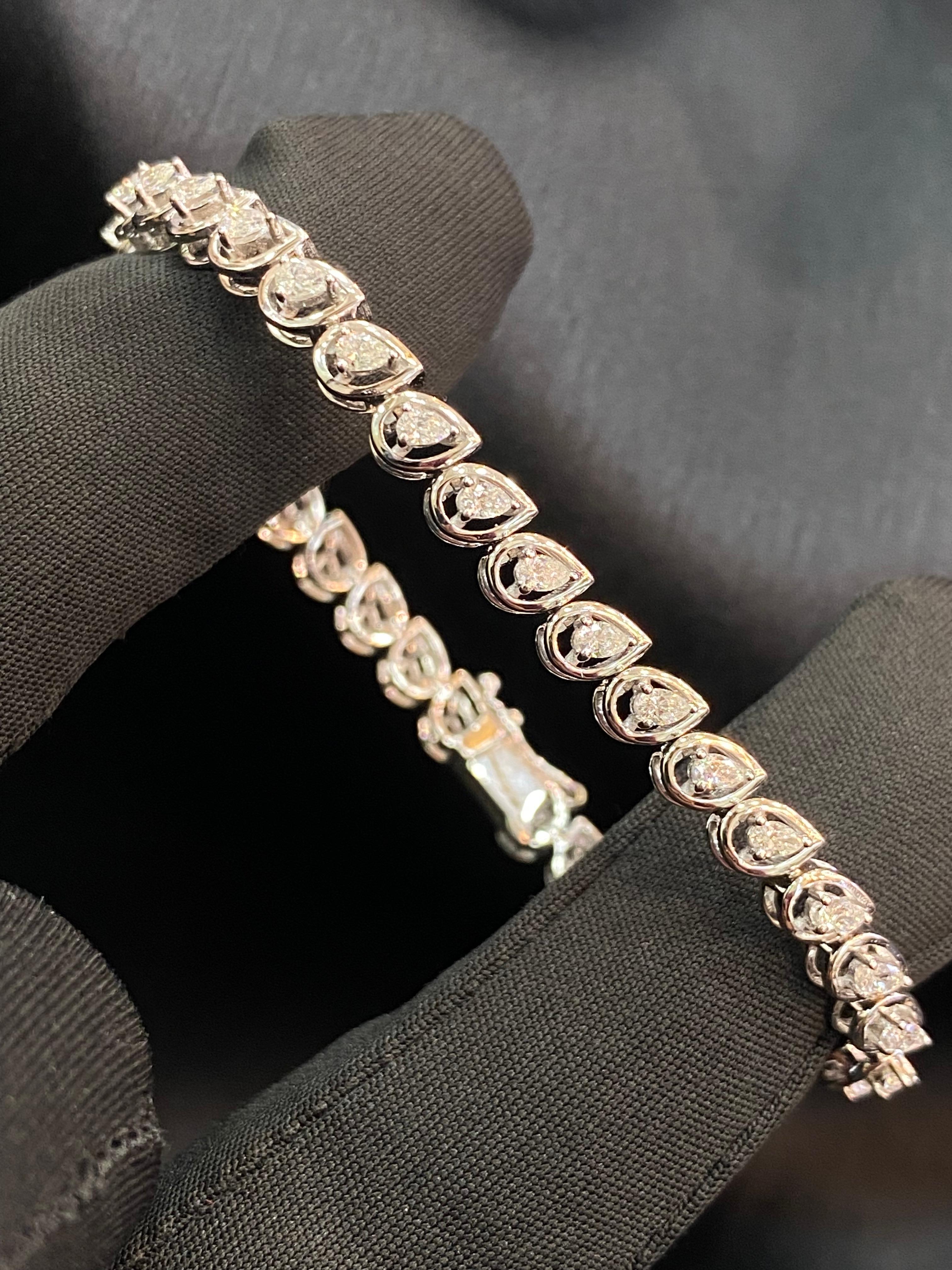 Indulge in the epitome of elegance with this bracelet, radiating glamour in its purest essence. Treat yourself to the mesmerizing beauty of this stunning 1.40 carat F/VS1 pear-shaped diamond bracelet, designed to illuminate your smile and exude