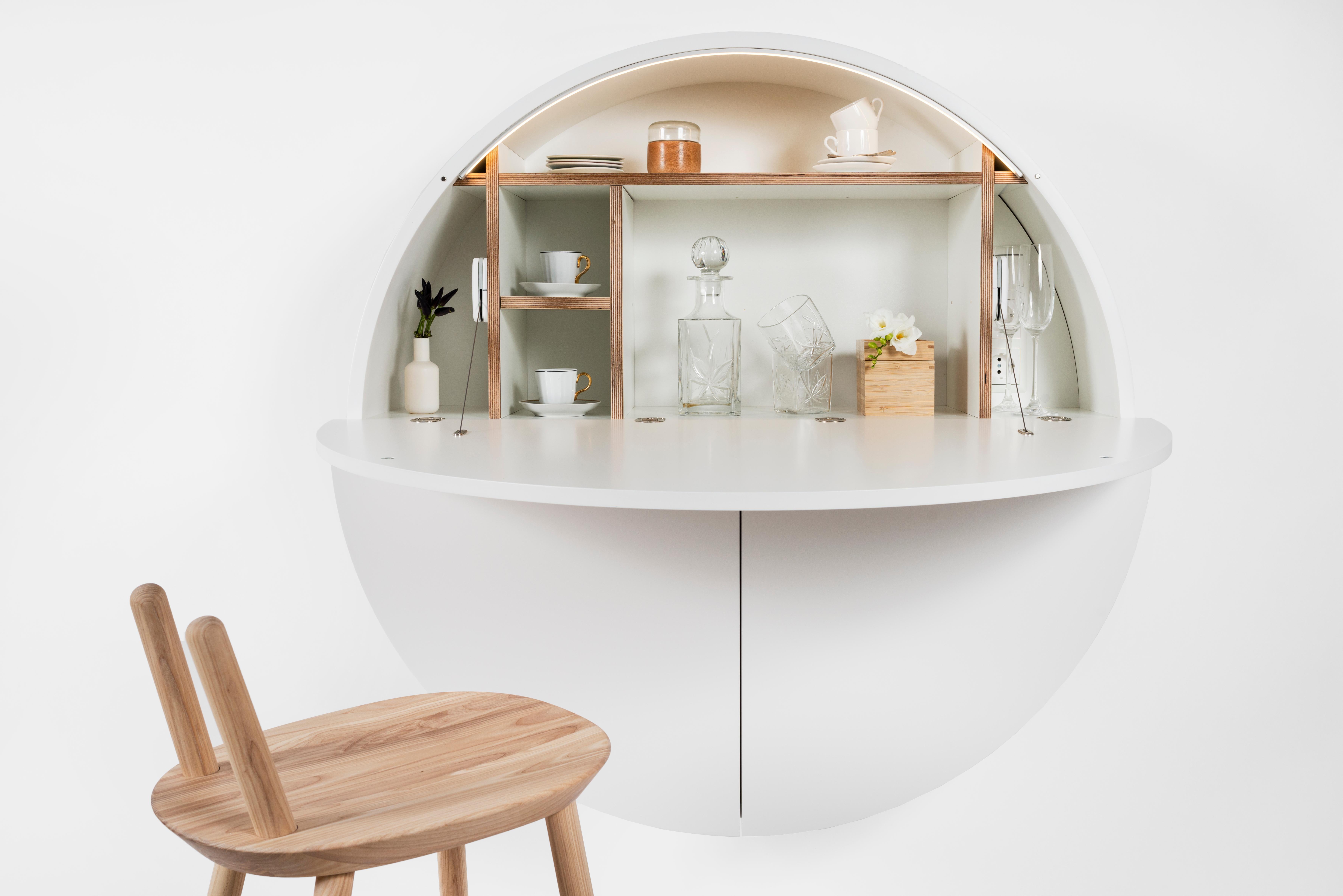 The Multifunctional Pill works great in the treatment against clutter and messy environments. The Pill is a round cabinet that works fixed to a wall and can instantly transform into a fully-functional working place, a dressing table, or even a