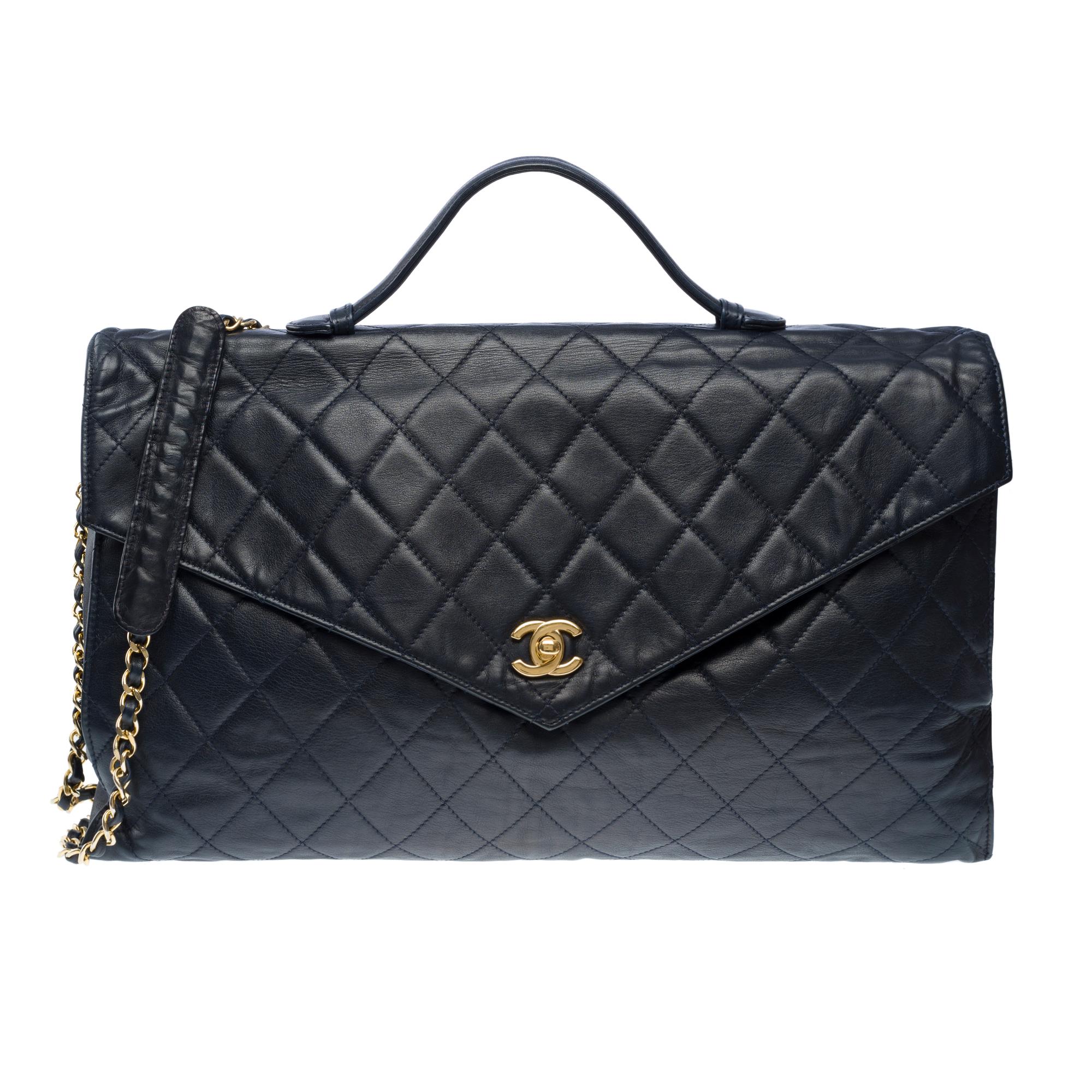 Chanel Briefcase bag in navy blue quilted lambskin leather , gold metal trim, handle and shoulder strap in gold metal interlaced with navy lambskin leather for hand or shoulder carry

Patch pocket on the back
CC logo closure in gold metal on