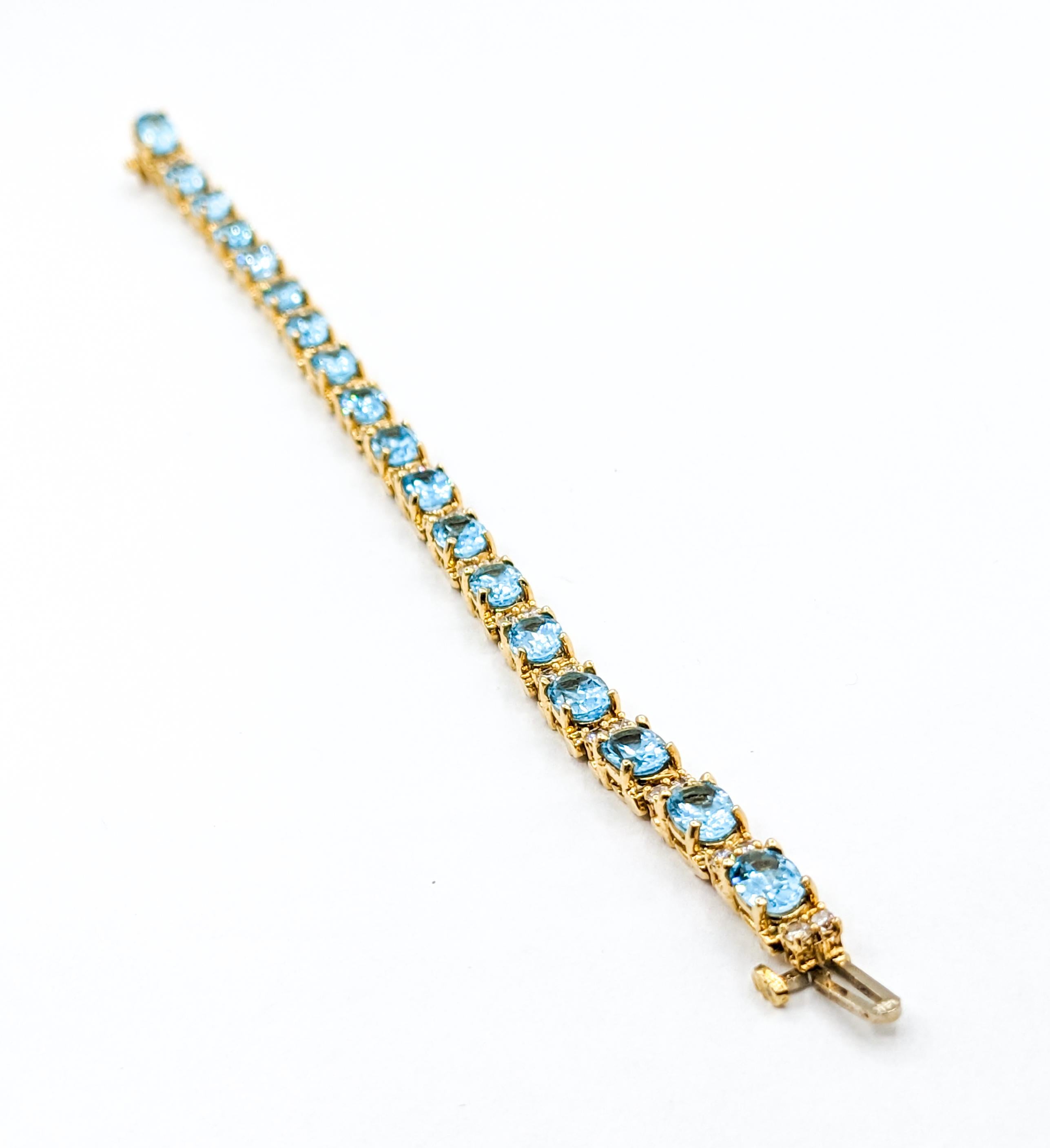 Classy Diamond & Blue Topaz Tennis Bracelet in Gold In Excellent Condition For Sale In Bloomington, MN