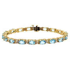 Classy Diamond & Blue Topaz Tennis Bracelet in Gold
