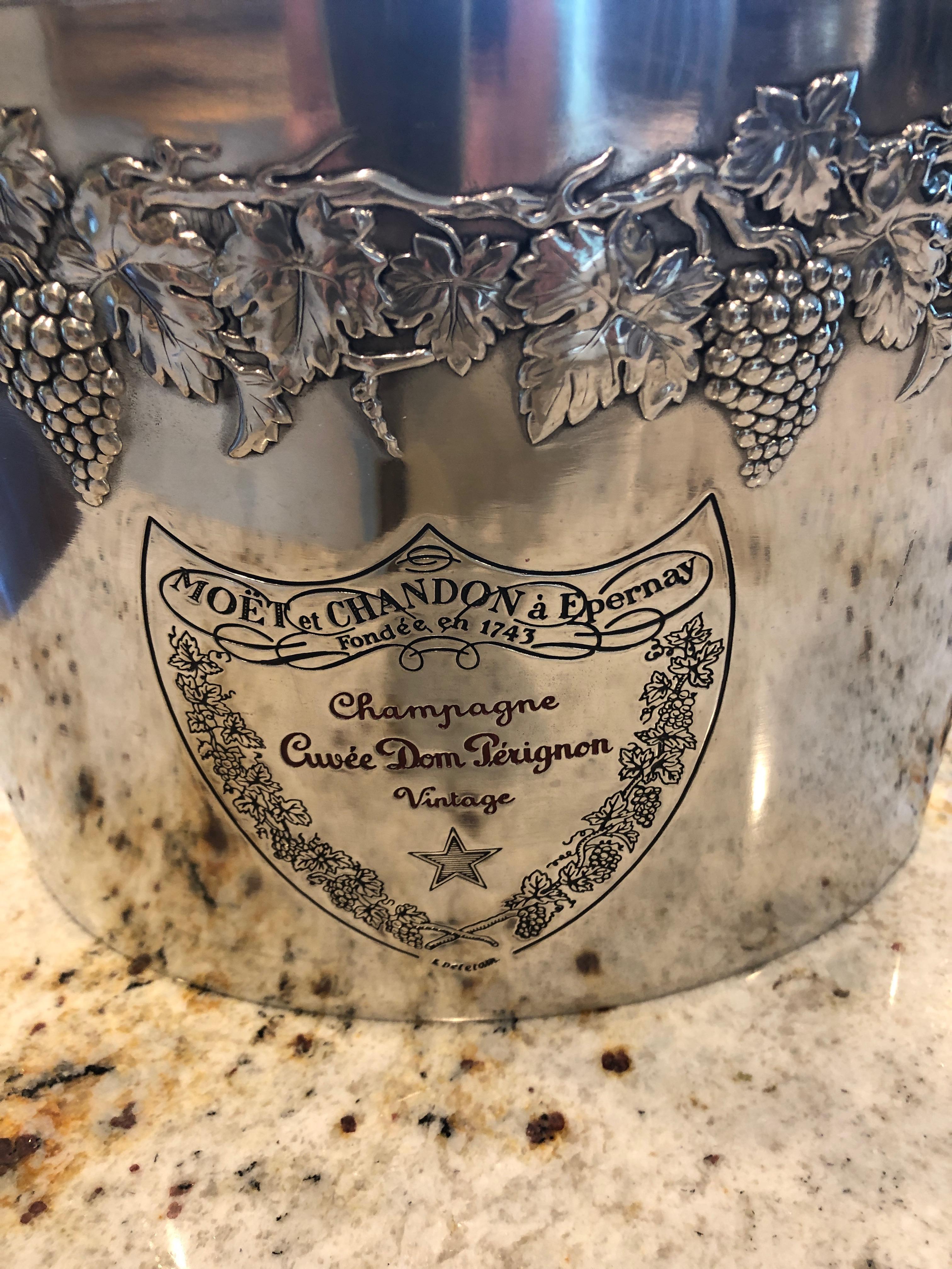 A gorgeous heavy pewter Moet & Chandon Dom Perignon double magnum champagne ice bucket having decorative grapes and leaves around the top, a classy shield shaped label engraved on the front, heavy loop handles on each side and oblong in shape. Will