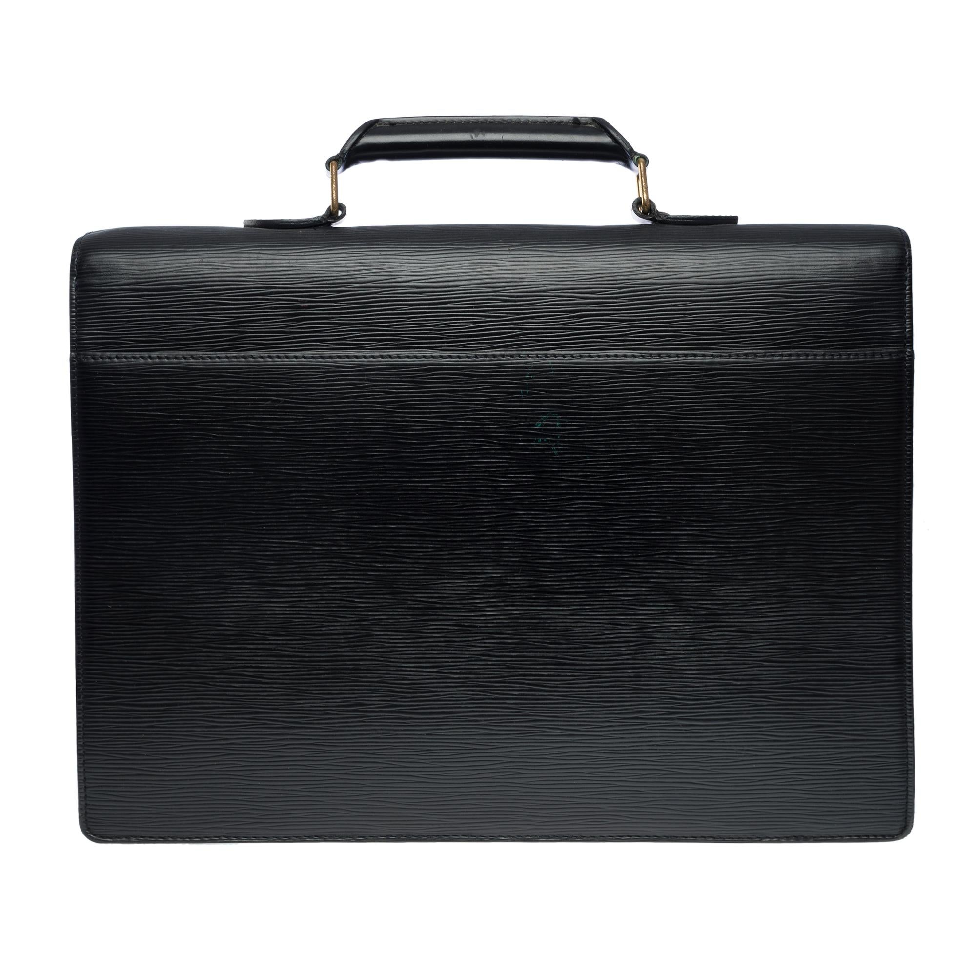 Classy Louis Vuitton Ambassador briefcase in black epi leather, gold metal hardware, simple black leather handle for hand carrying

Flap closure by lock clasp
A patch pocket on the back of the bag
Black leather inner lining, 2 compartments, 1 patch
