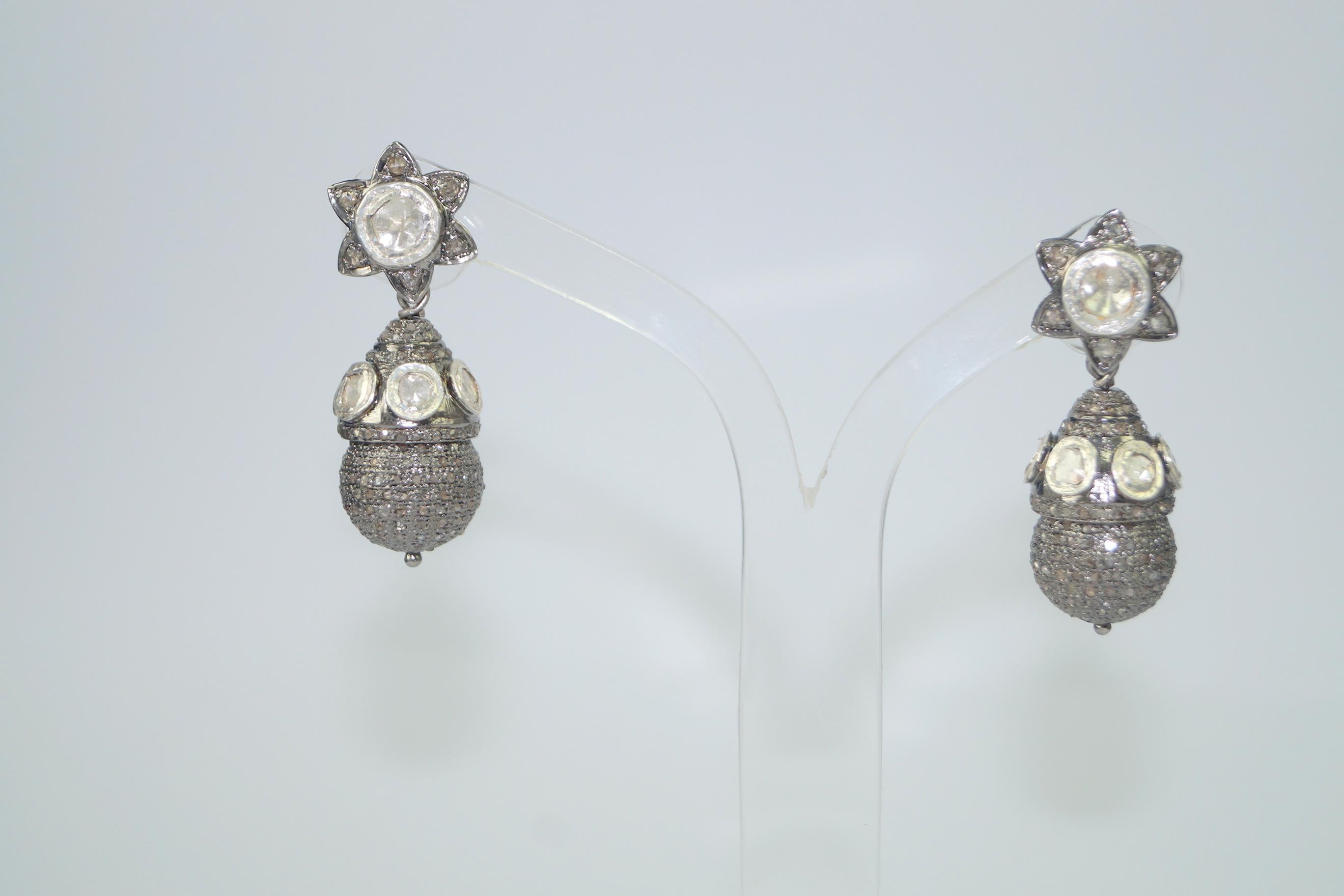 The beautiful elegant natural diamond sterling silver dangle earrings consists of-

Diamond type- Natural Uncut rose cut diamonds
Diamond color- White with a tint of brown
Diamond weight- 4.95cts 

Metal- sterling silver
Metal color- oxidized silver