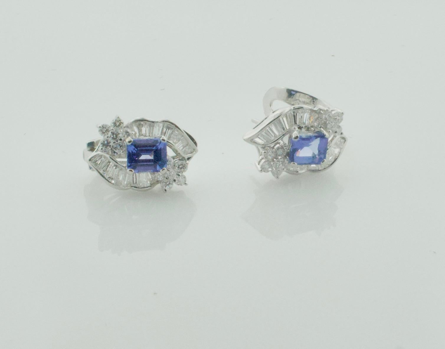 Classy Tanzanite and Diamond Earrings in 18k White Gold
2 Emerald Cut Tanzanites Weighing 1.90 Carats Approximately [bright with no imperfections visible to the naked eye]
32 Tapered Baguette Cut Diamonds Weighing 1.00 Carats Approximately 
24 Round
