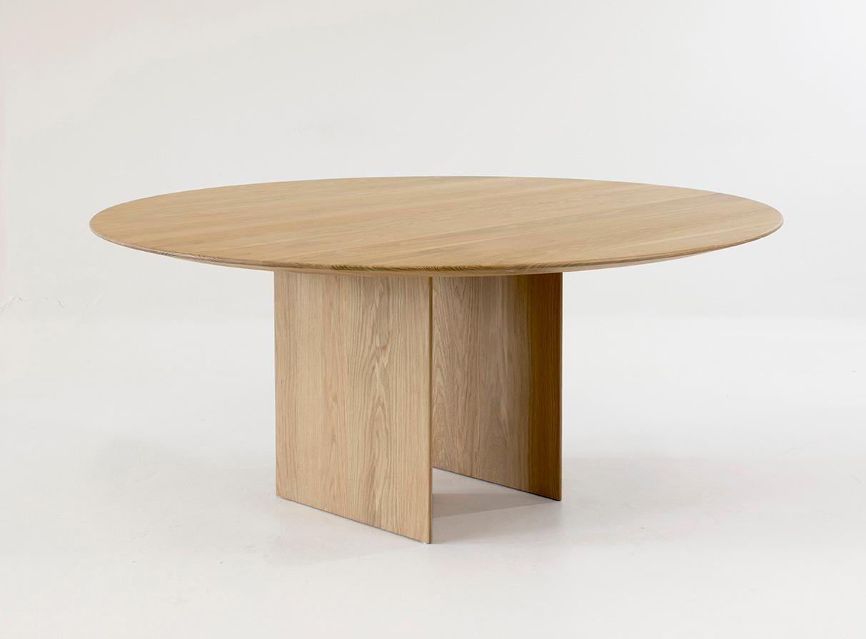 The round version of this table explores similar ideas as its rectangular sibling where the offset base allows for a variety of differing visuals depending on the line of sight. Available in both wood and marble this table can be customized to fit