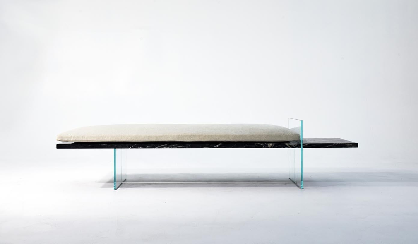 The strong horizontal line created by the marble slab of this bench is accentuated by the cantilevered shelf which is separated from the seat by a vertical blade of glass. This seemingly impossible cantilever is achieved without any concealed