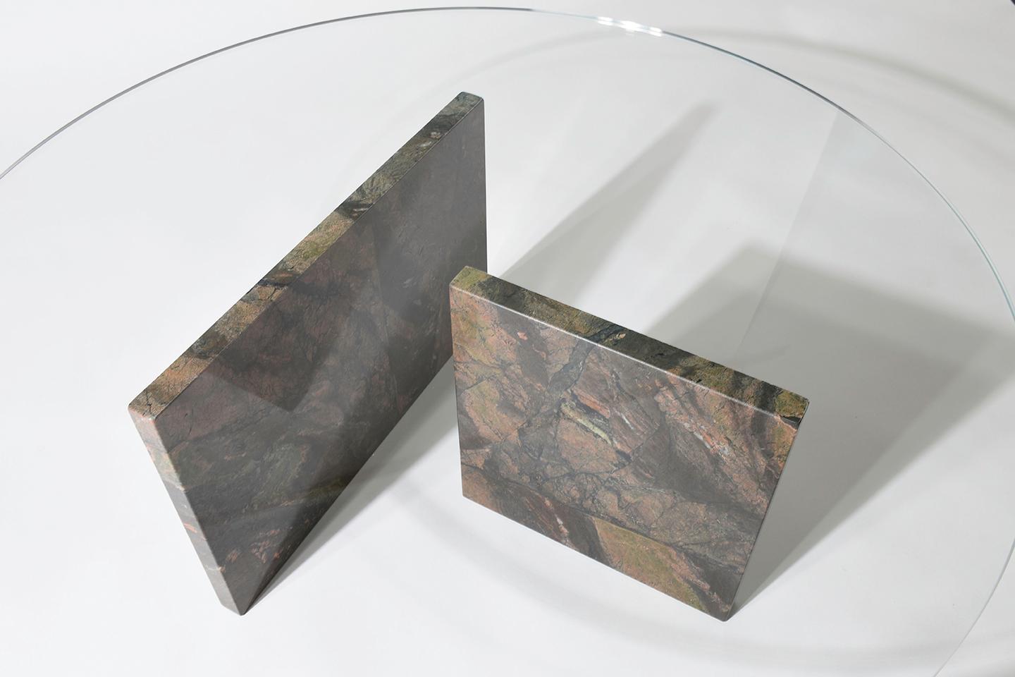 The two freestanding marble legs, seemingly precariously balanced beneath the floating plane of glass create an almost magical feel for this coffee table as there seems to be no logical explanation for why it does not collapse. Available in both