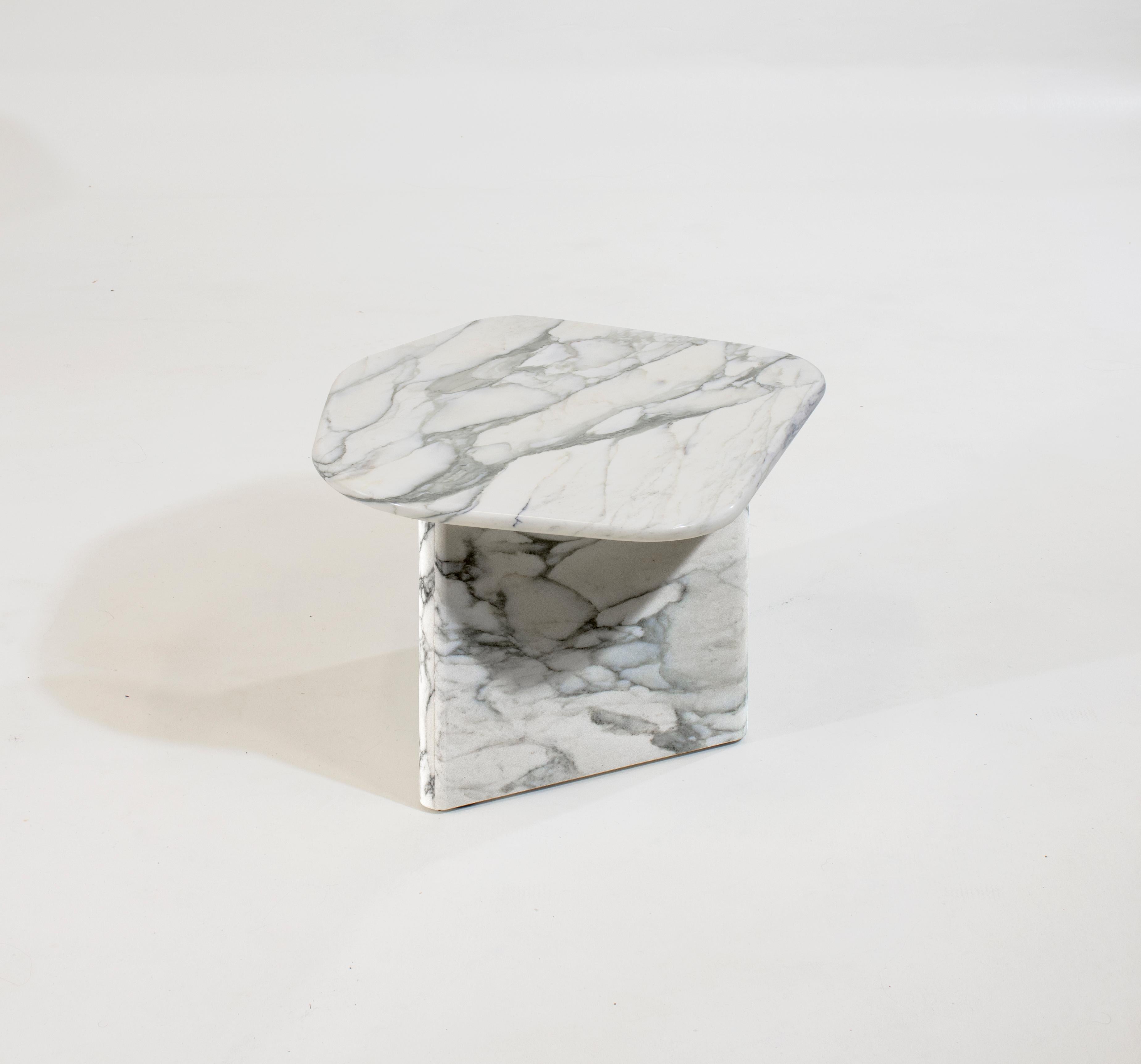 Developed as a side table version of the Collected Memory series of coffee tables this piece can be customized in size and height to work with any layout. It is a piece that plays with asymmetry to create a solid marble table that has a sense of