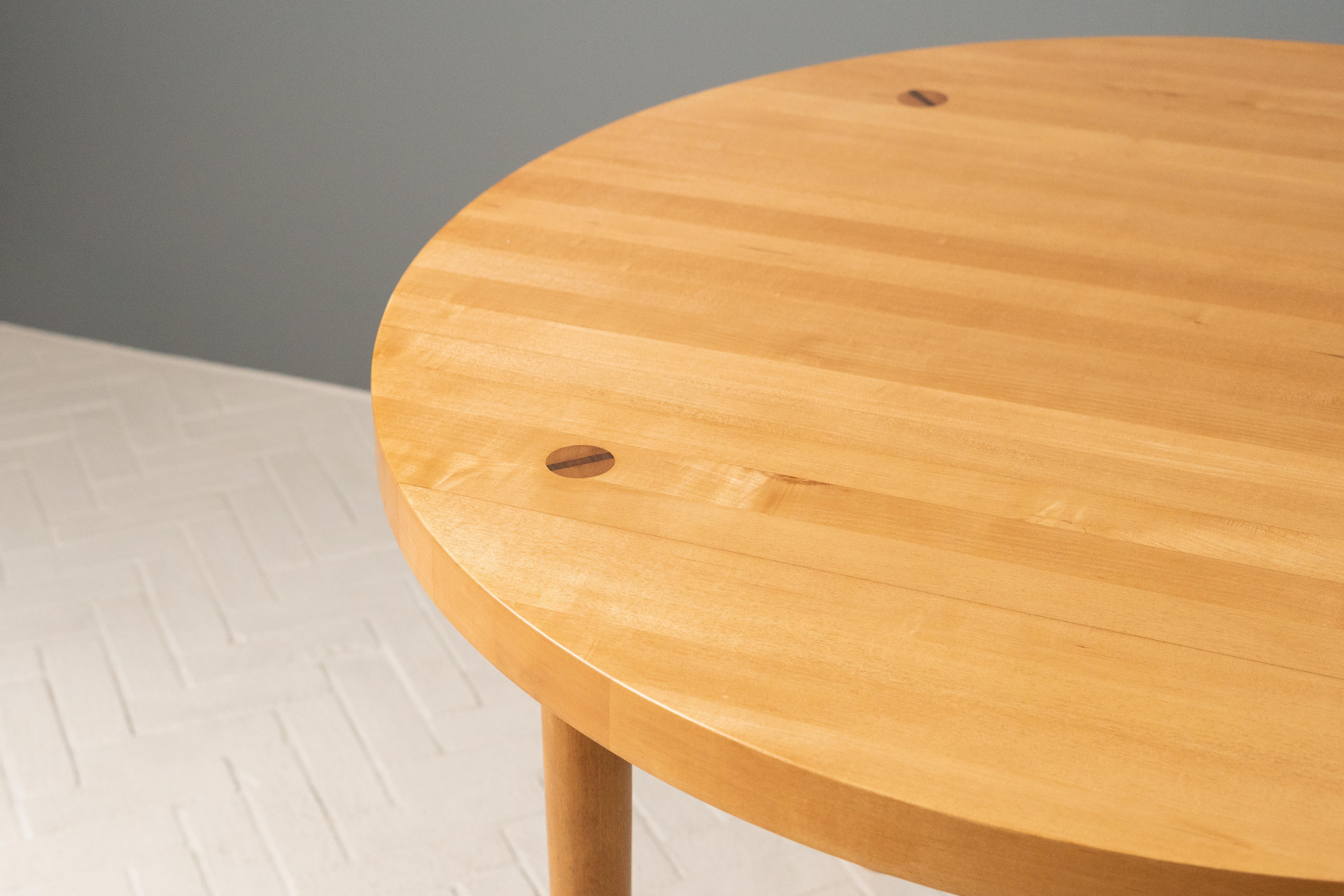 USA, ca. 1960s. A functional and durable dining table by Claud Bunyard for Design Research - manufactured by local cabinetmaker Charles Webb. Features solid round maple butcher block top supported by sturdy tapered legs. Wedged leg tenons to top not