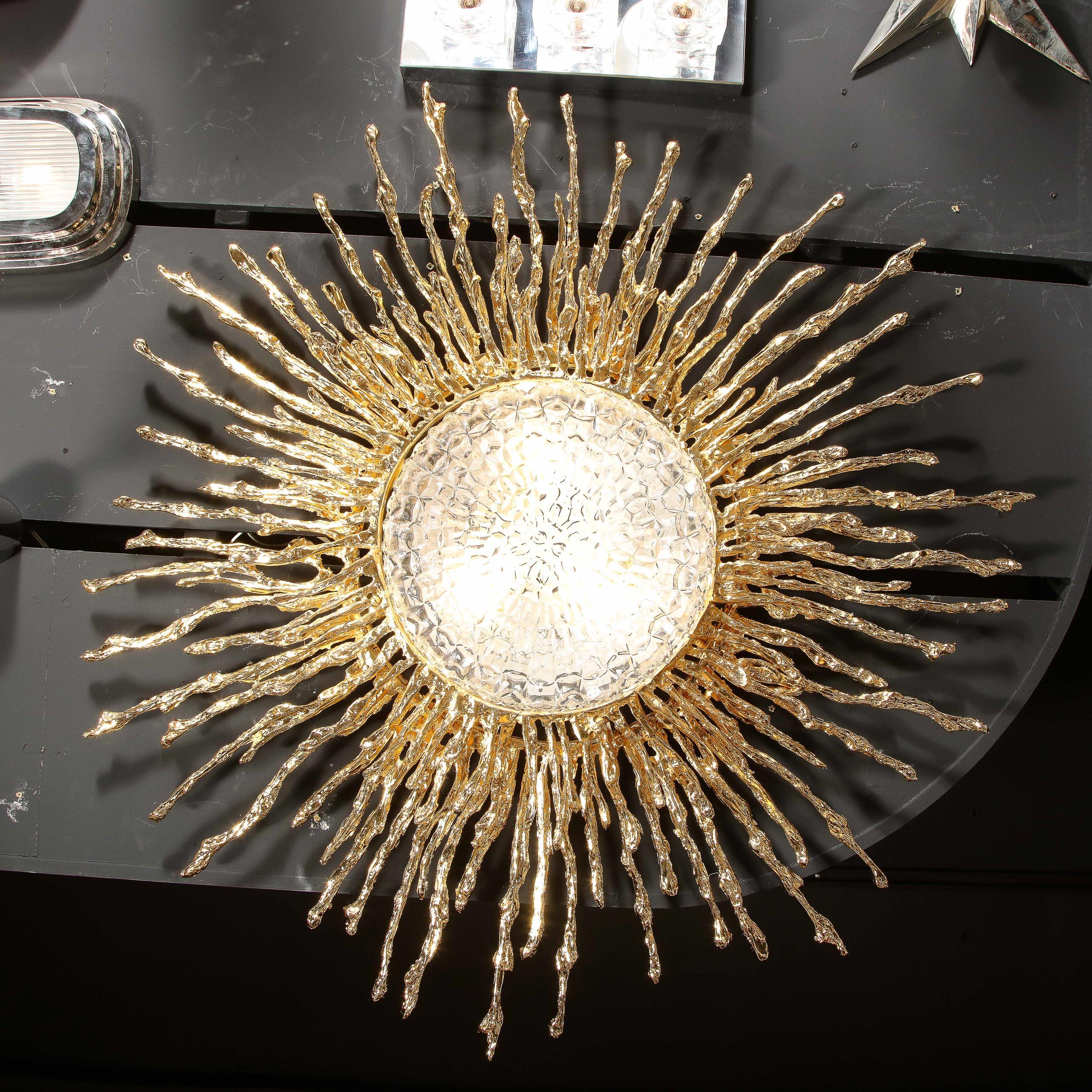 This stunning and dramatic flush mount chandelier was hand crafted by the esteemed artist Claude Boeltz in France. It features an expressionistic sunburst pattern realized in two rows of exploded bronze plated in pure 24-karat yellow gold, the