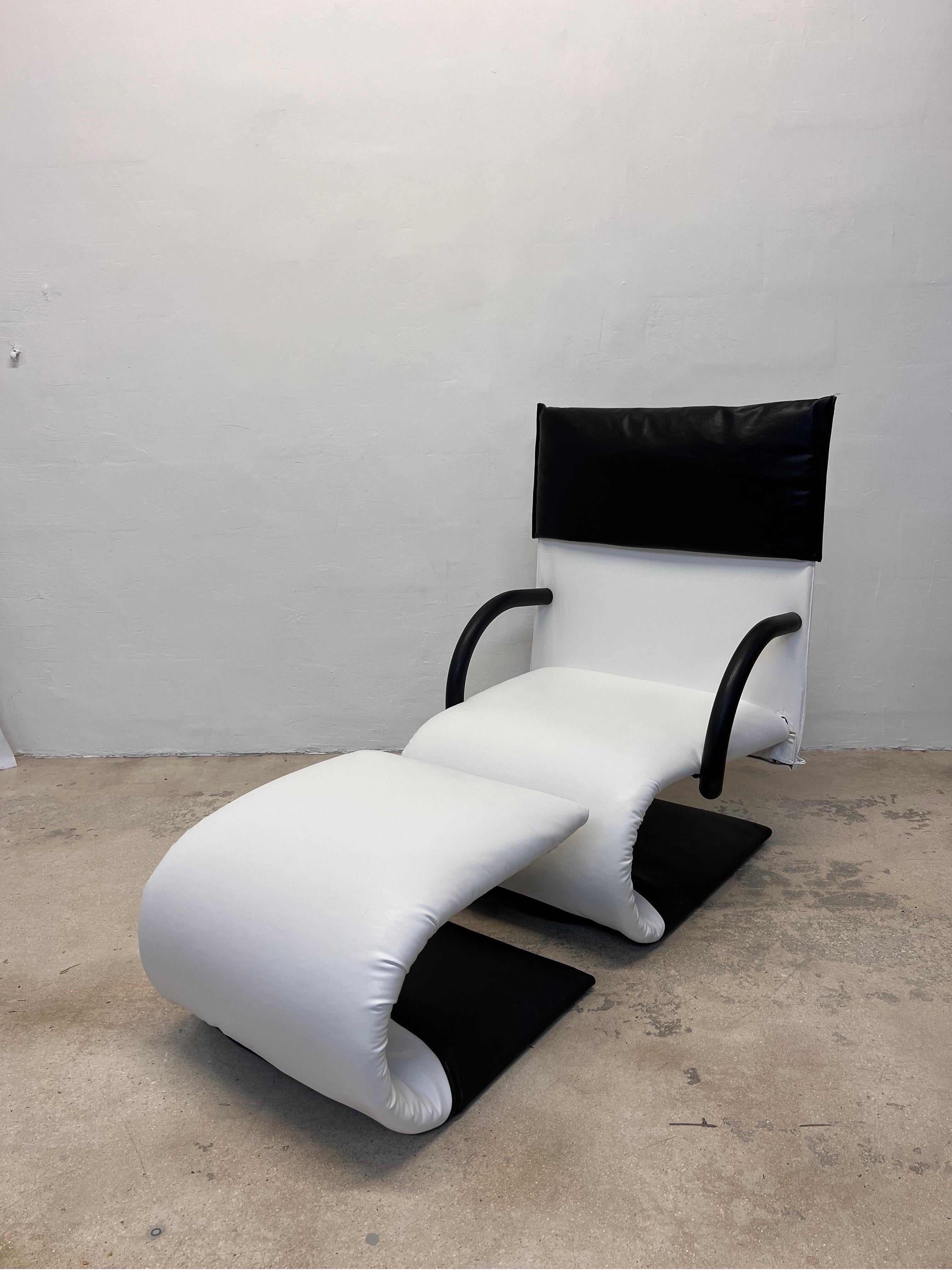 Postmodern Zen lounge chair and footrest by Claude Brisson for Ligne Roset, France 1980s. Rendered in black and white vegan leather upholstery with black removable headrest protector.

This set has been newly upholstered in vegan leather from