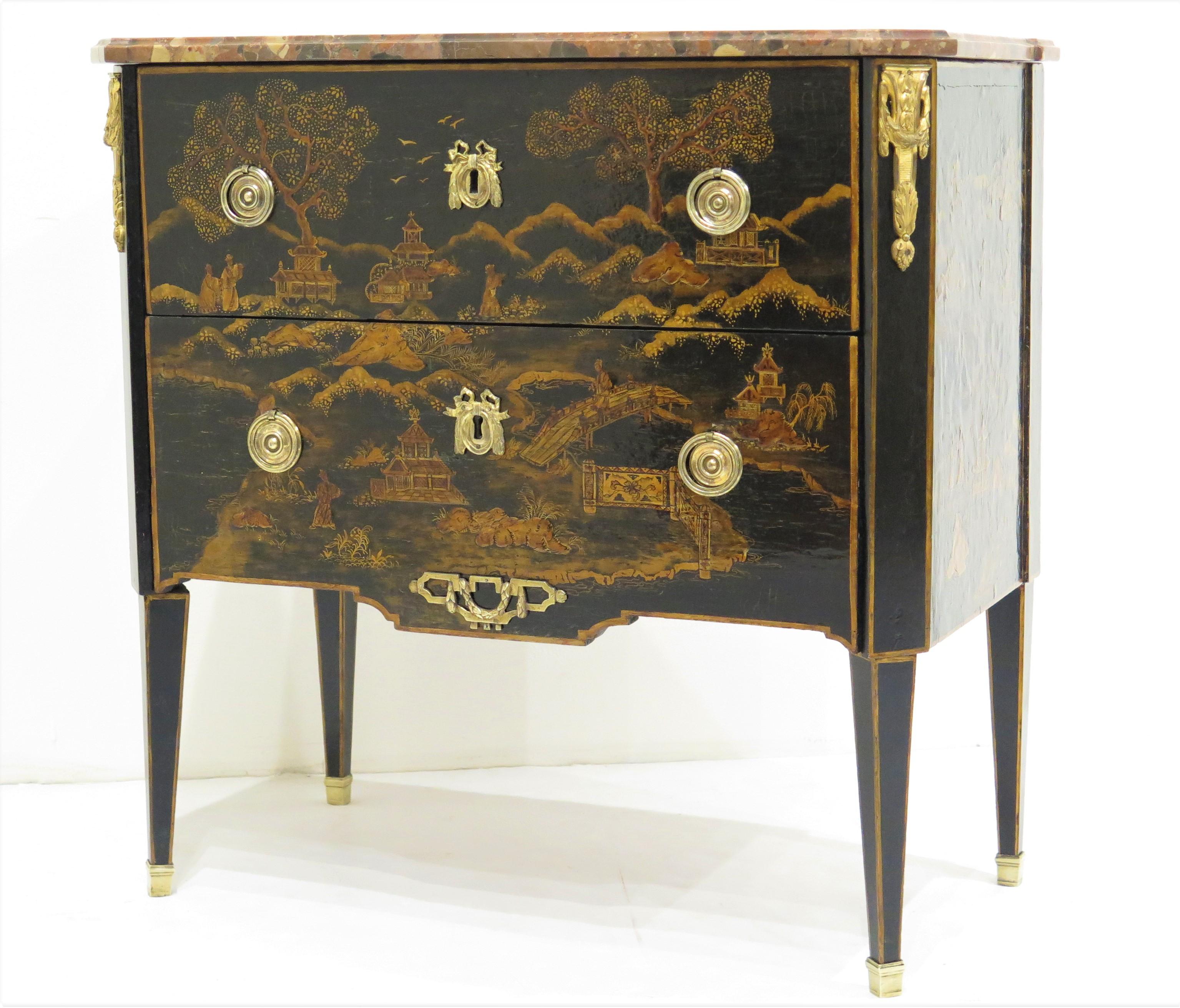 a petite period Louis XVI two-drawer commode black lacquer with gold Chinoserie decoration, gilt bronze mounts, elegant round / ring pulls, beautiful keyhole escutcheons with bows, and having a shaped conforming red and grey veined marble top, on