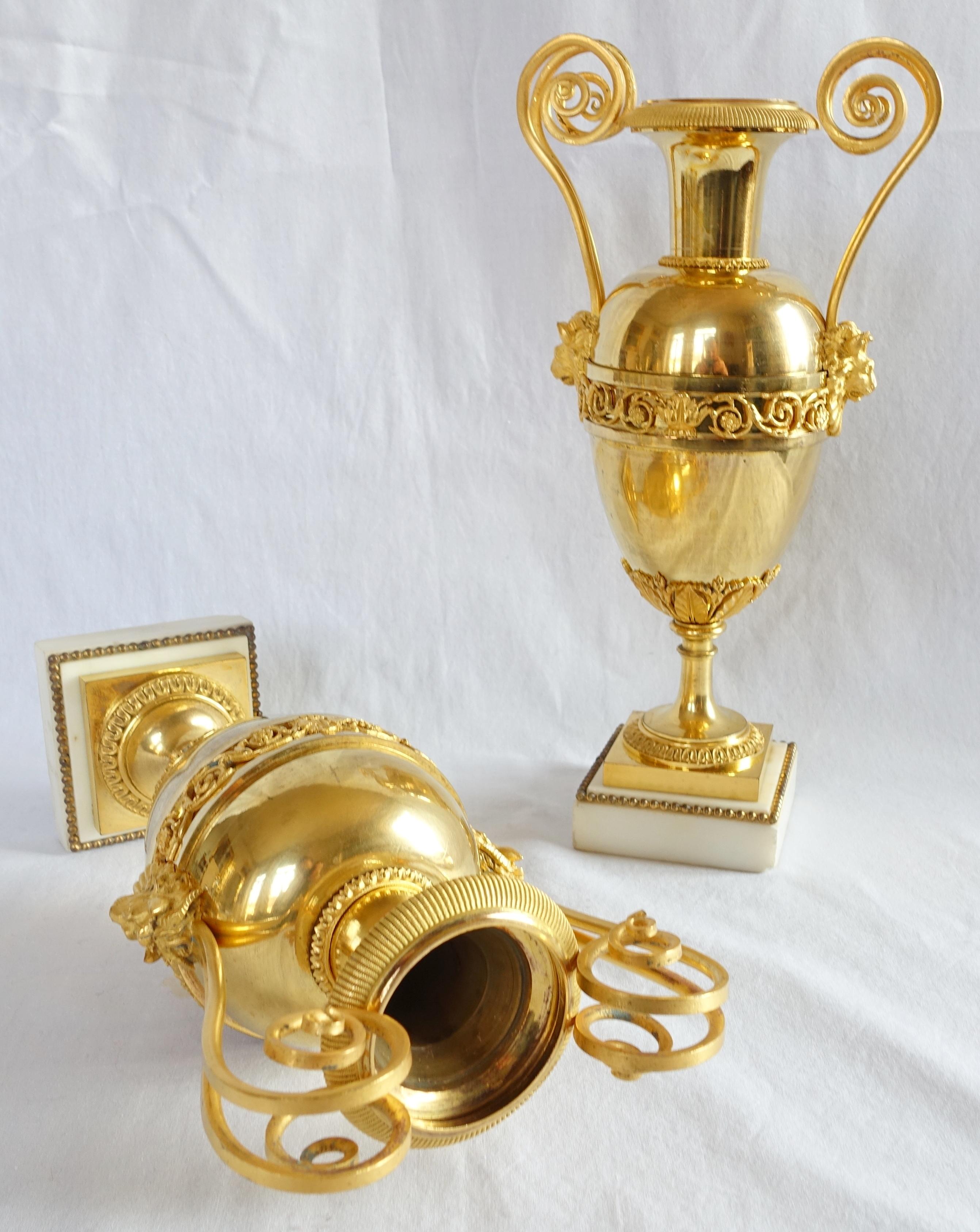 A fine pair of ormolu amphora-shaped urns standing on marble pedestals, late 18th century or Empire period circa 1800. High end production attributed to French bronze maker Claude Galle : finely chiseled Empire friezes, gilt finish, two subtly