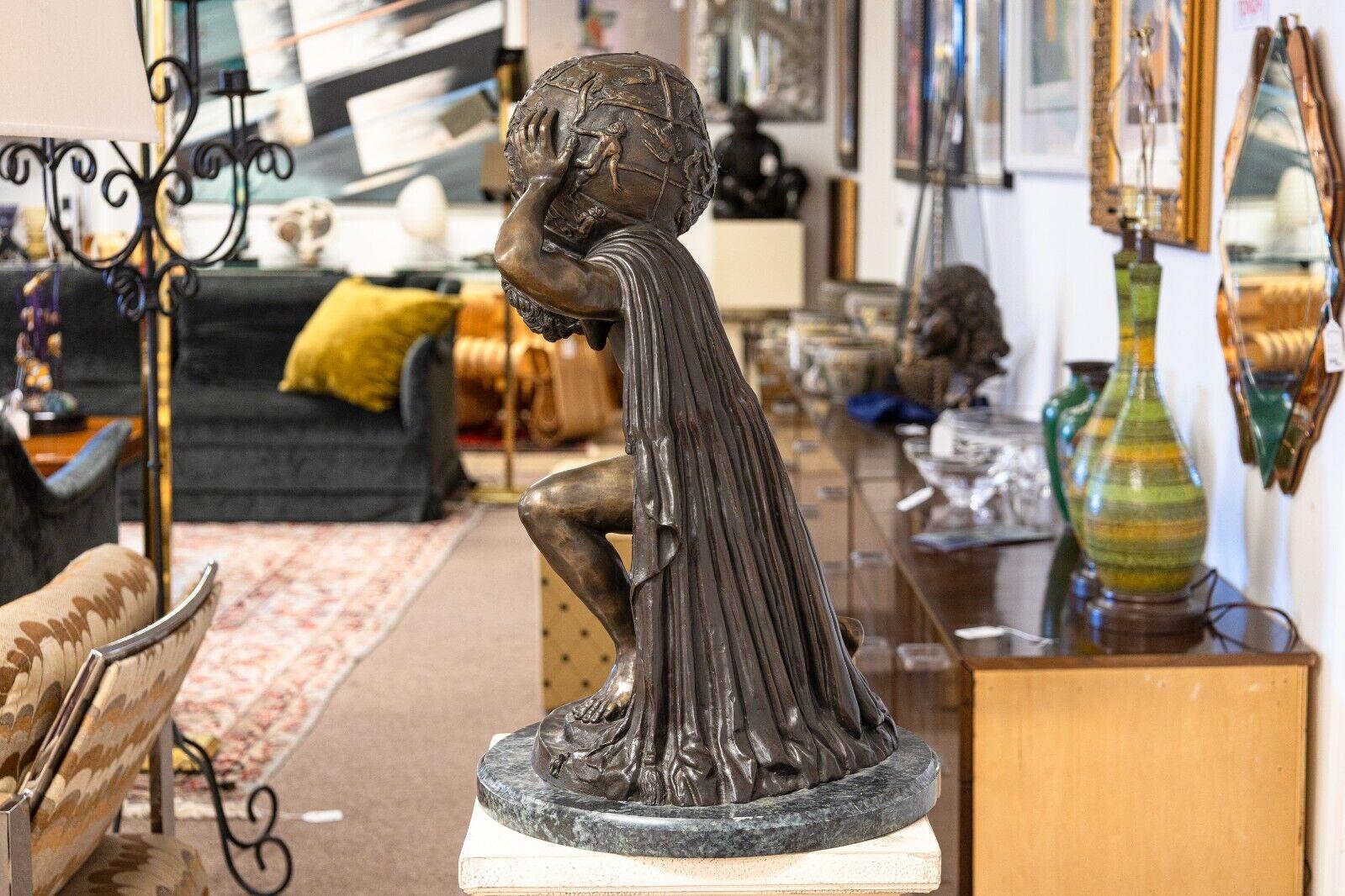 This grand bronze sculpture, inspired by the works of Michel C. Clodion, depicts the mythological figure of Atlas bearing the weight of the world on his shoulders. The intricate detailing of Atlas's muscular form and the richly textured globe