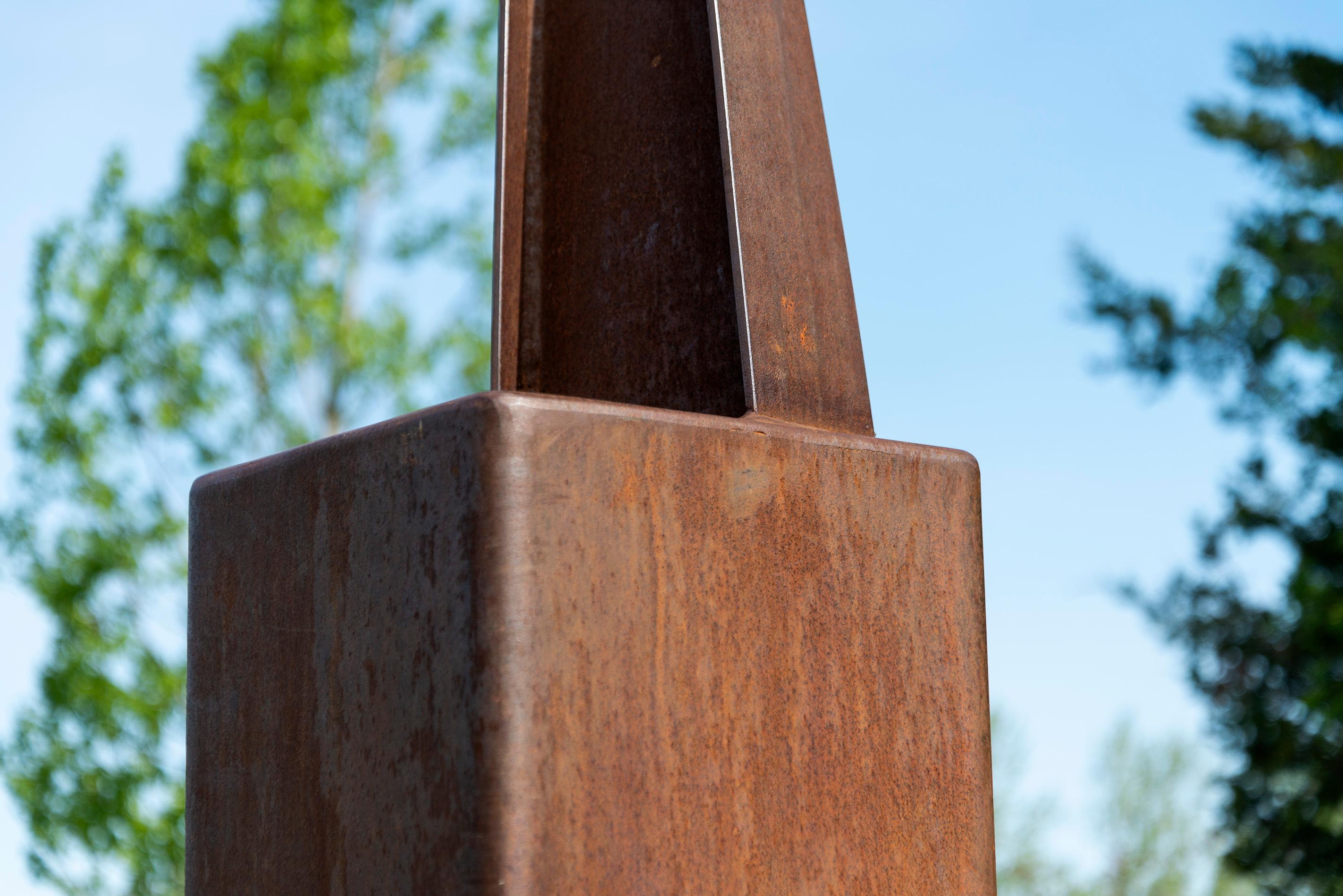 An elegantly curved column of corten steel appears to almost float in mid-air in this arresting outdoor sculpture by Claude Millette. The Quebec artist whose career spans four decades is known for his imaginative abstract work that plays with the