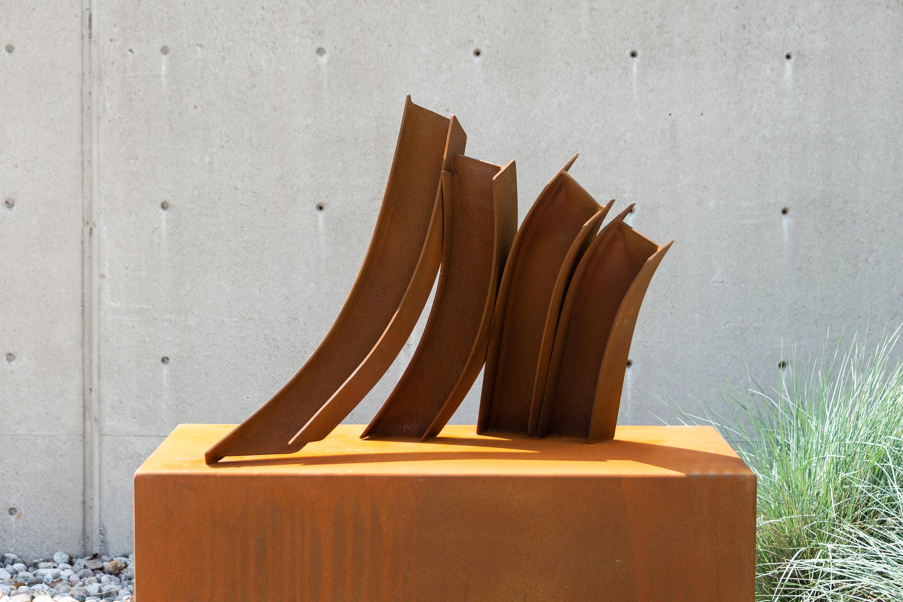 Claude Millette often draws inspiration for his modern sculptures from the graceful movement of dancers. This series of gently curved corten steel beams appear to interpret the natural fluid form of a dancer in motion. Each beam is set at a