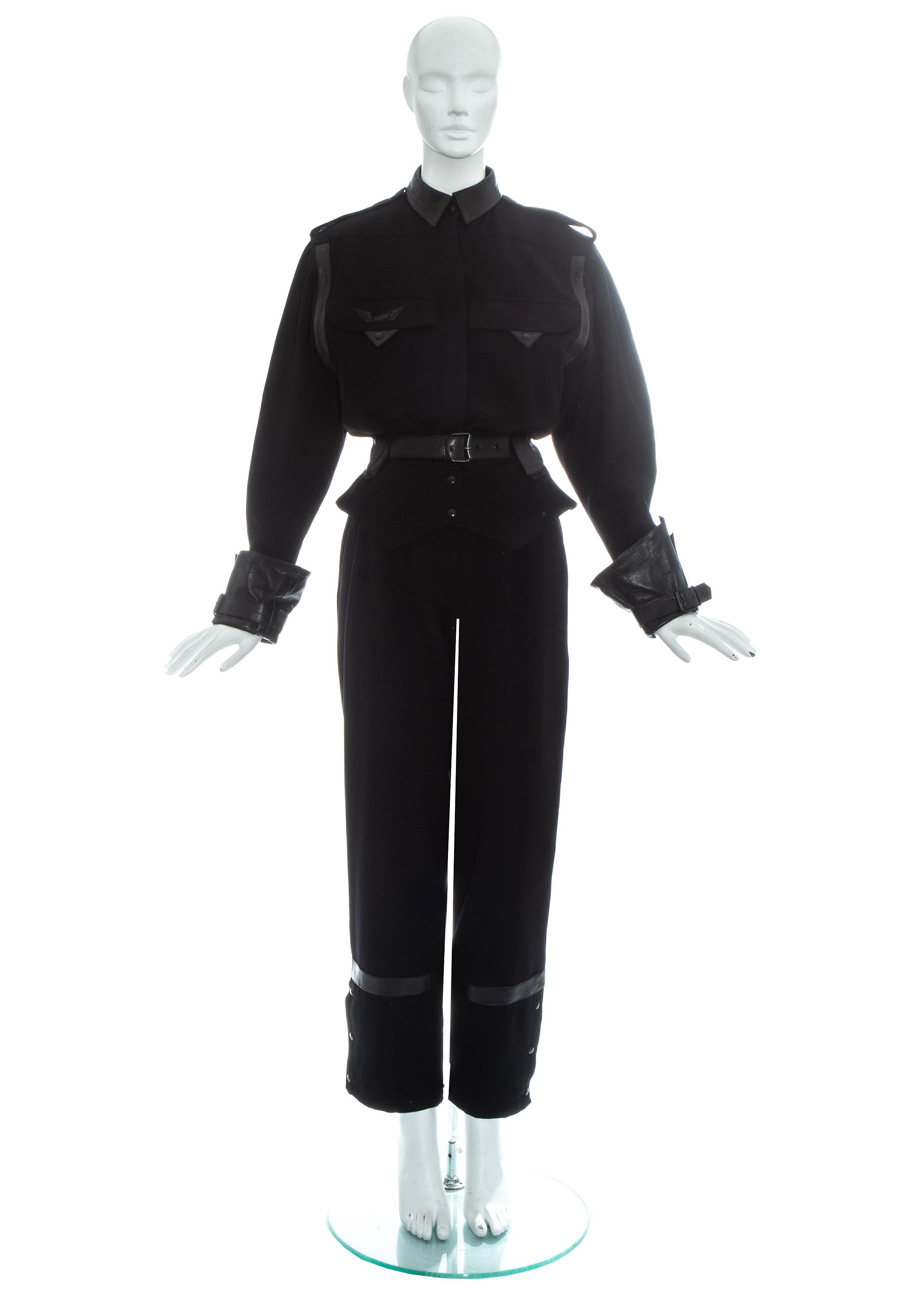 Claude Montana black wool and leather flight jumpsuit. Turn up cuffs, snap button closures, leather belt and peplum. 

Fall-Winter 1983