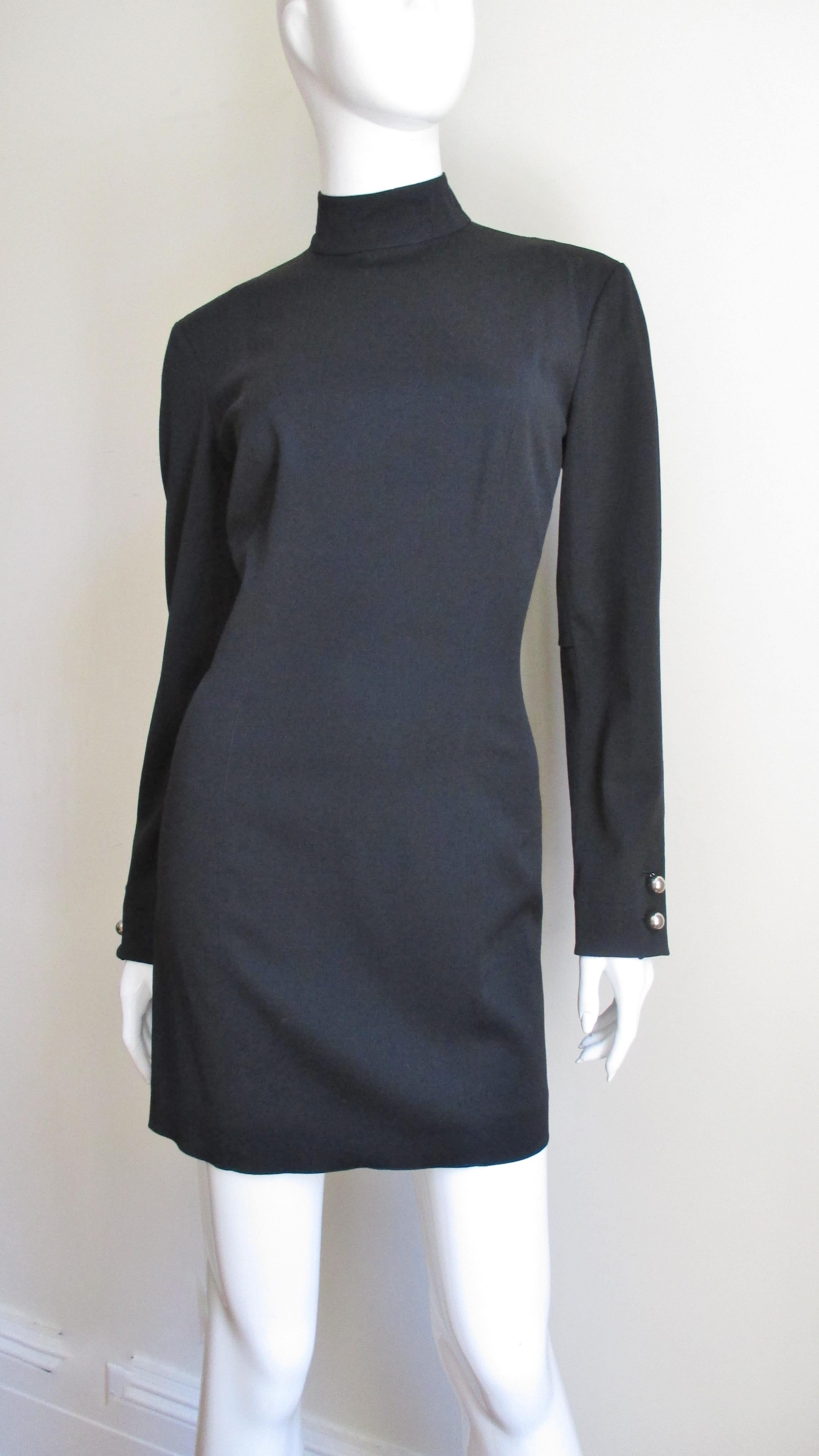 A fabulous light weight black wool (with some stretch) dress from Claude Montana.  It has princess seaming for a great fit, a stand up collar and silver metal ball button cuffs.  It is unlined with finished seams and a back zipper with a silver